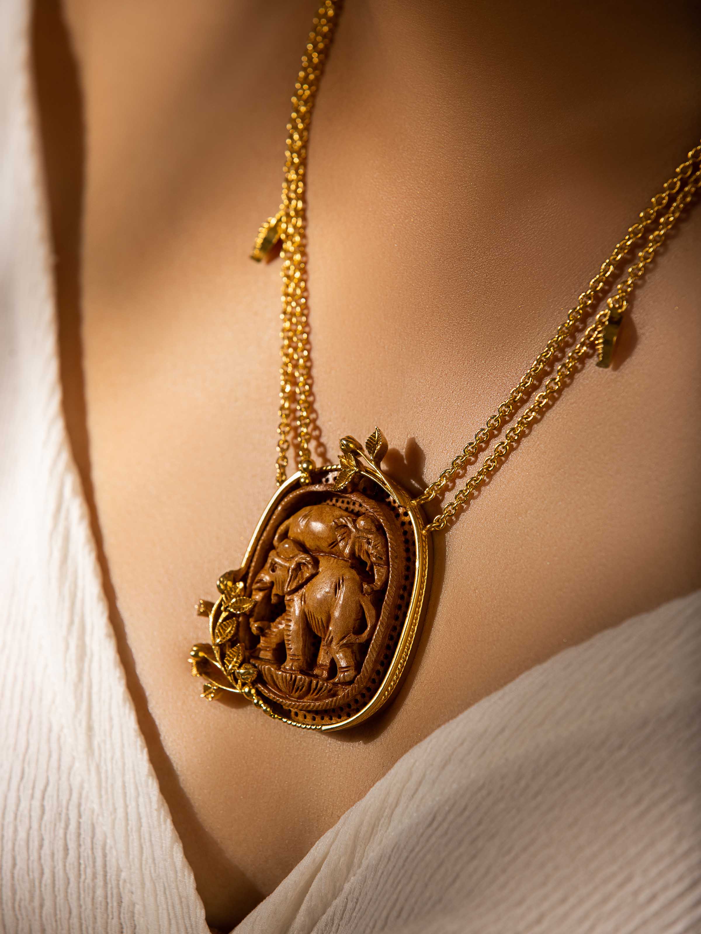 Second lifestyle view showing necklace draped over neutral-toned ensemble
