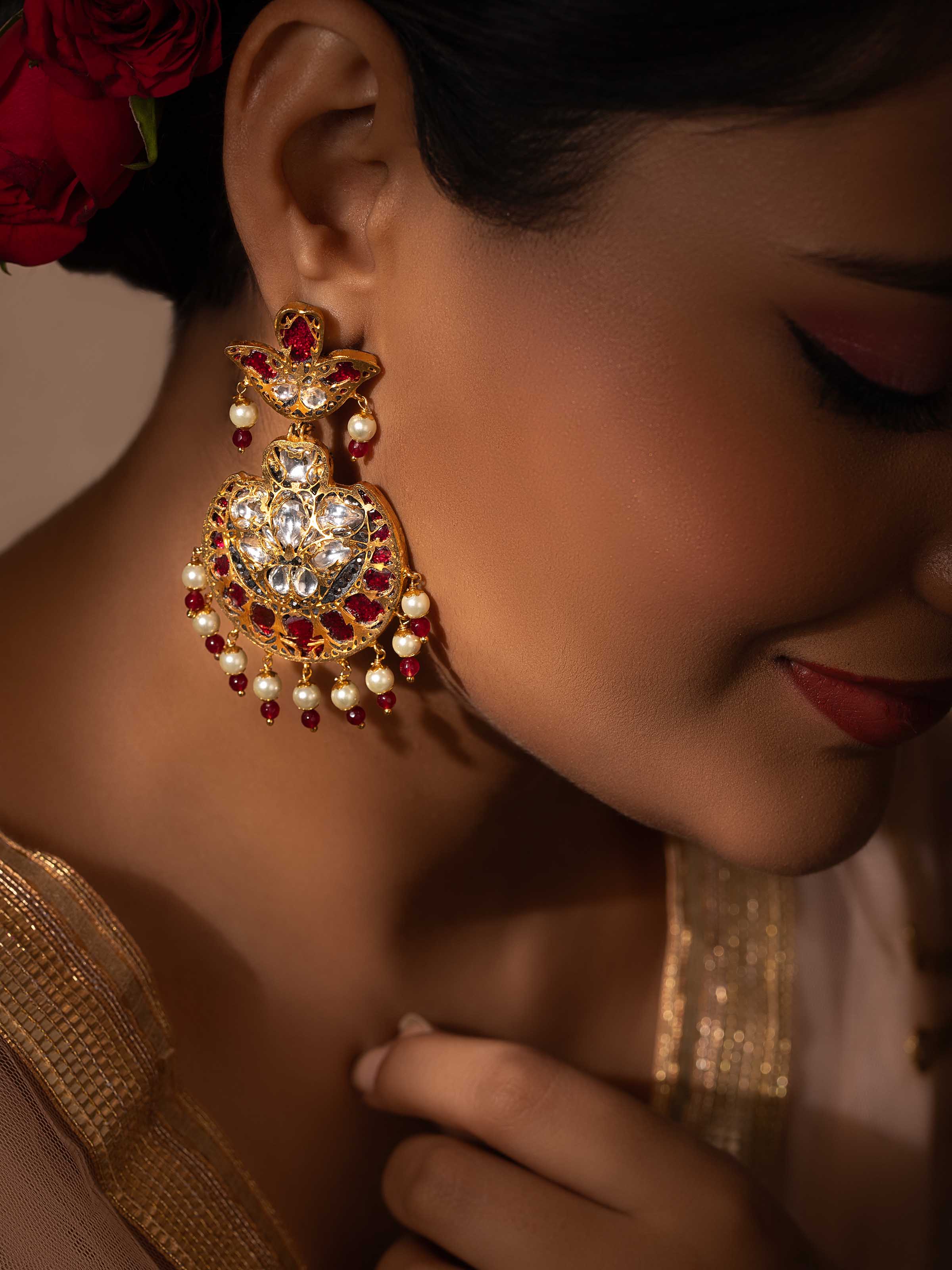 Close-up view of Bandhel metal drop earrings highlighting intricate details
