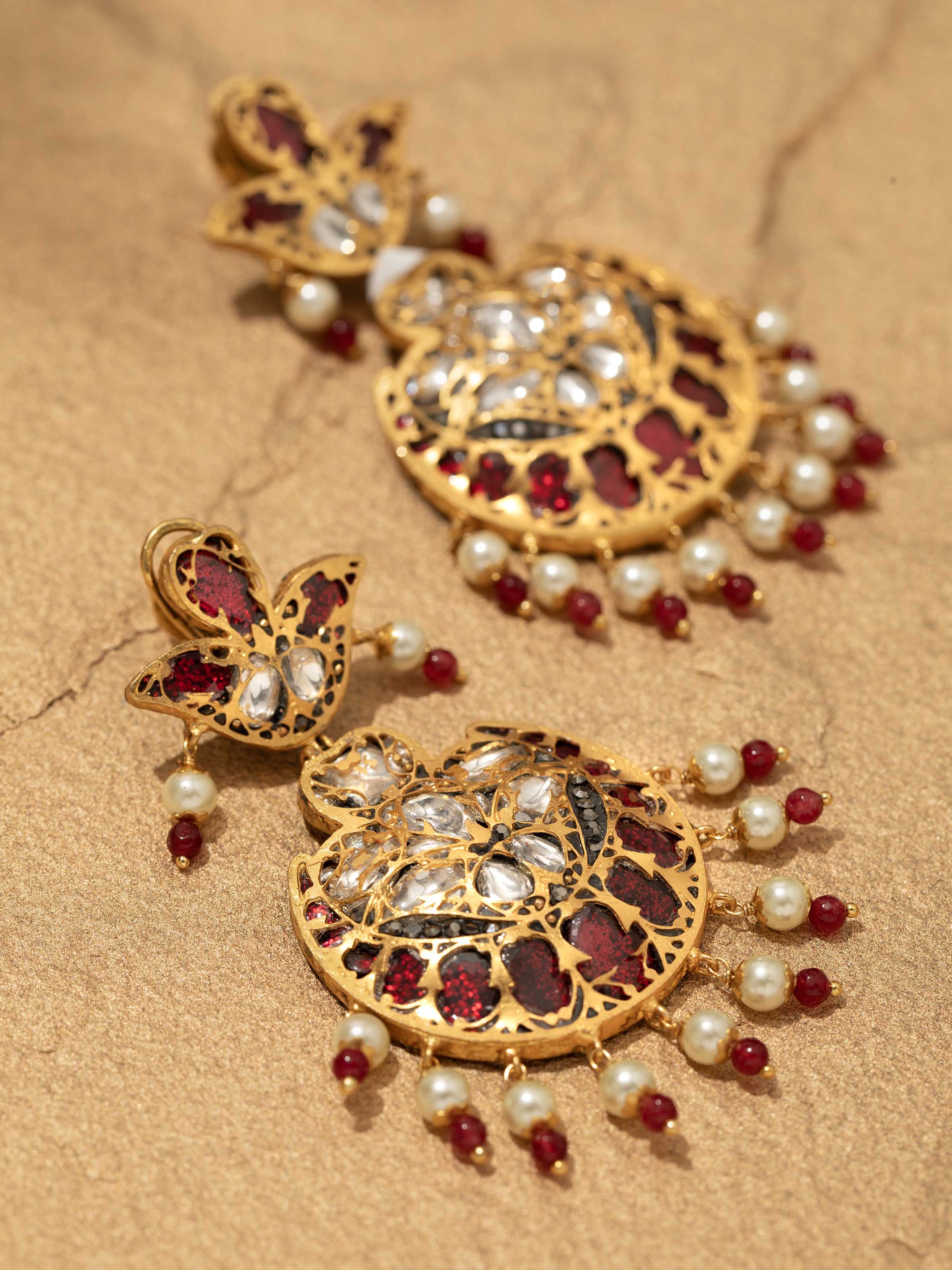 Detailed view of Bandhel metal drop earrings showcasing ornate patterns