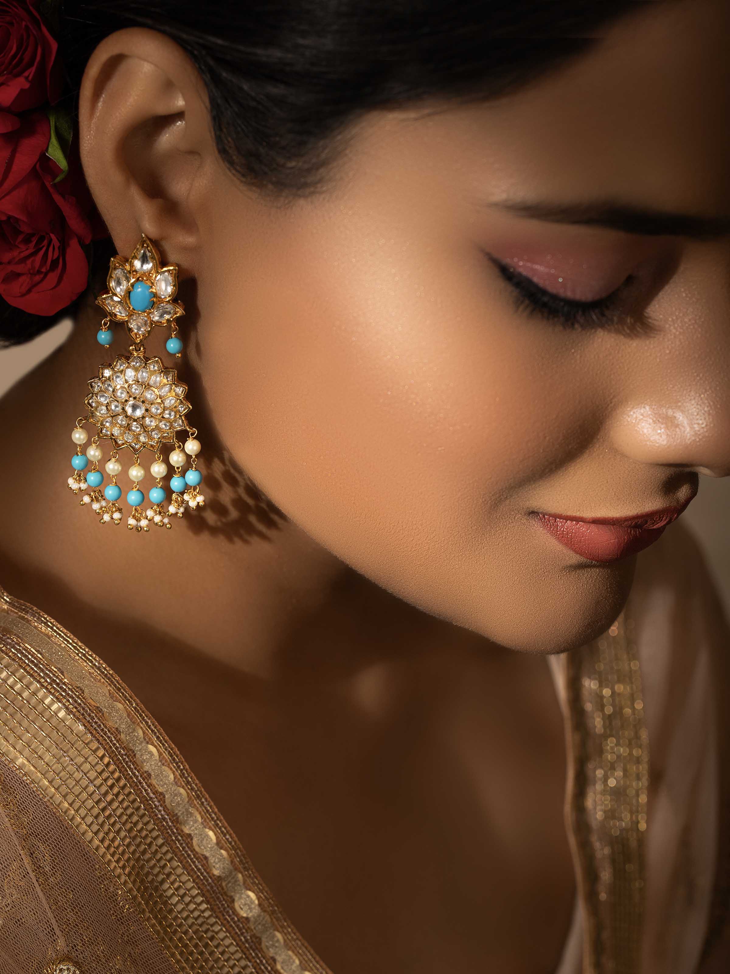 Side view of Bandhel metal drop earrings showcasing detailed metalwork and design