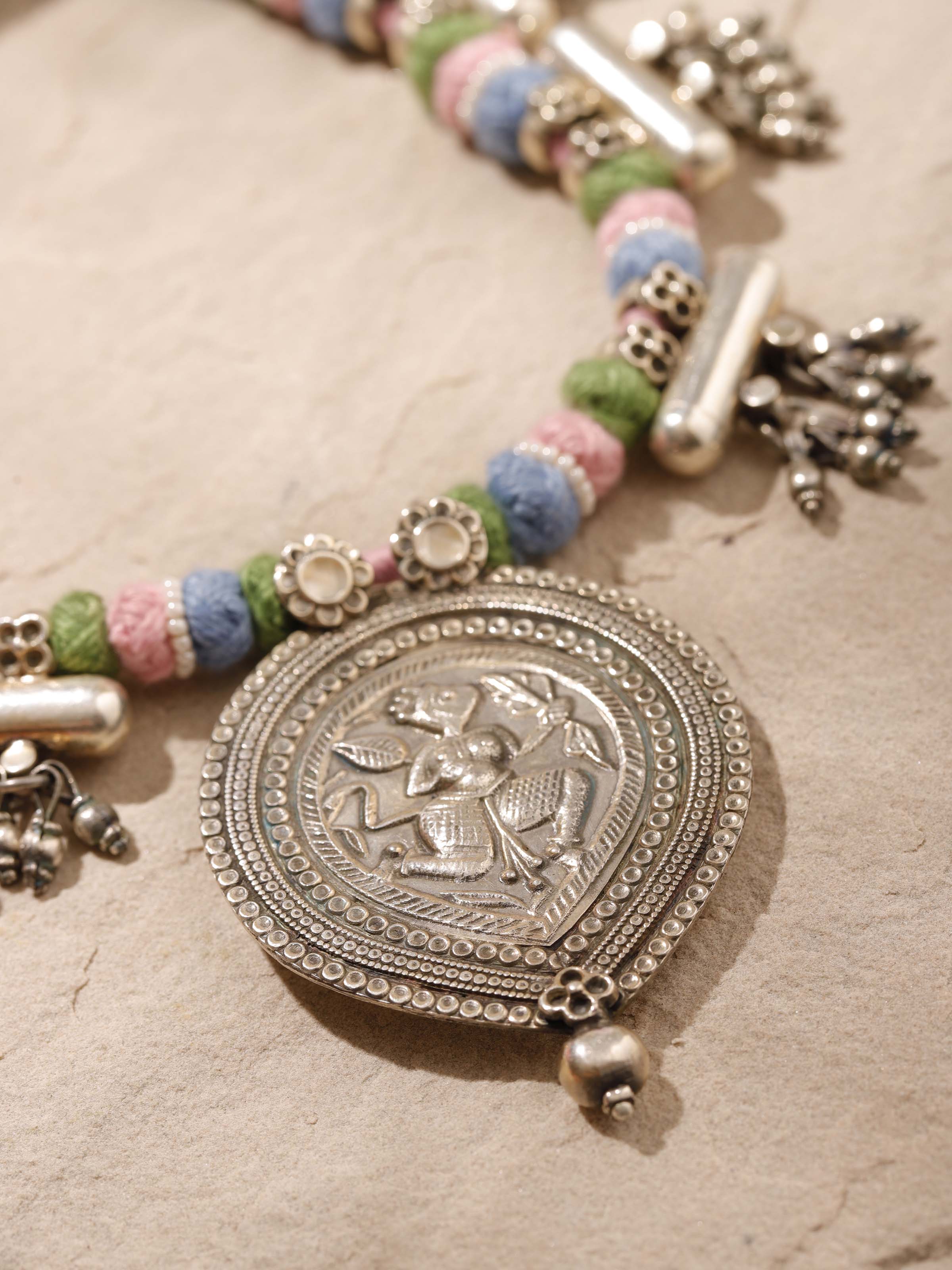 Angled view of Silver Smithing Collar Necklace showcasing the detailed silver work and elegant design