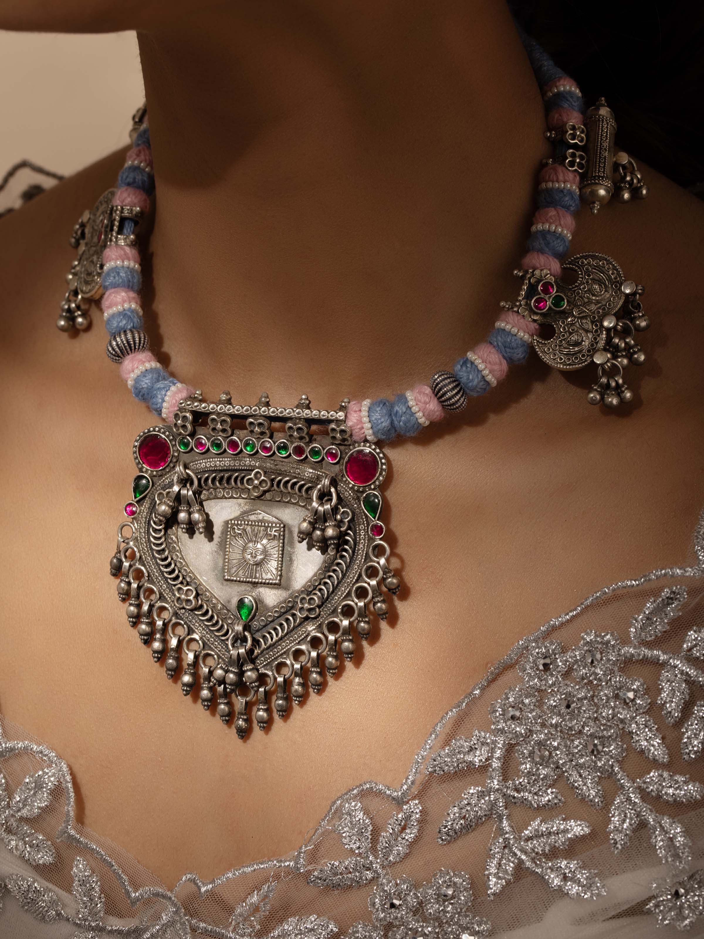 Close-up view of silver smithing collar necklace emphasizing detailed workmanship and texture