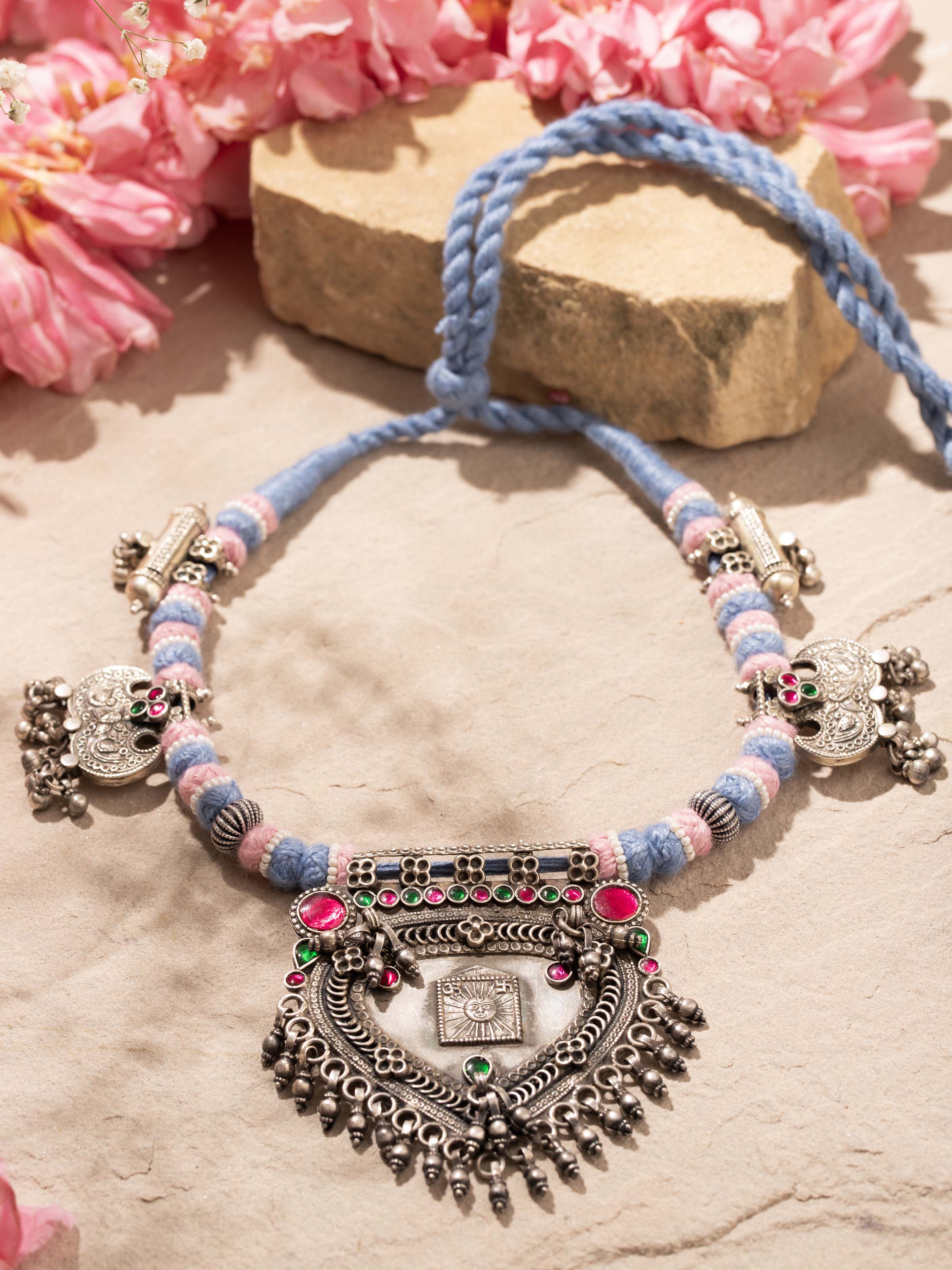 Angled view of silver smithing collar necklace focusing on craftsmanship and detailed design