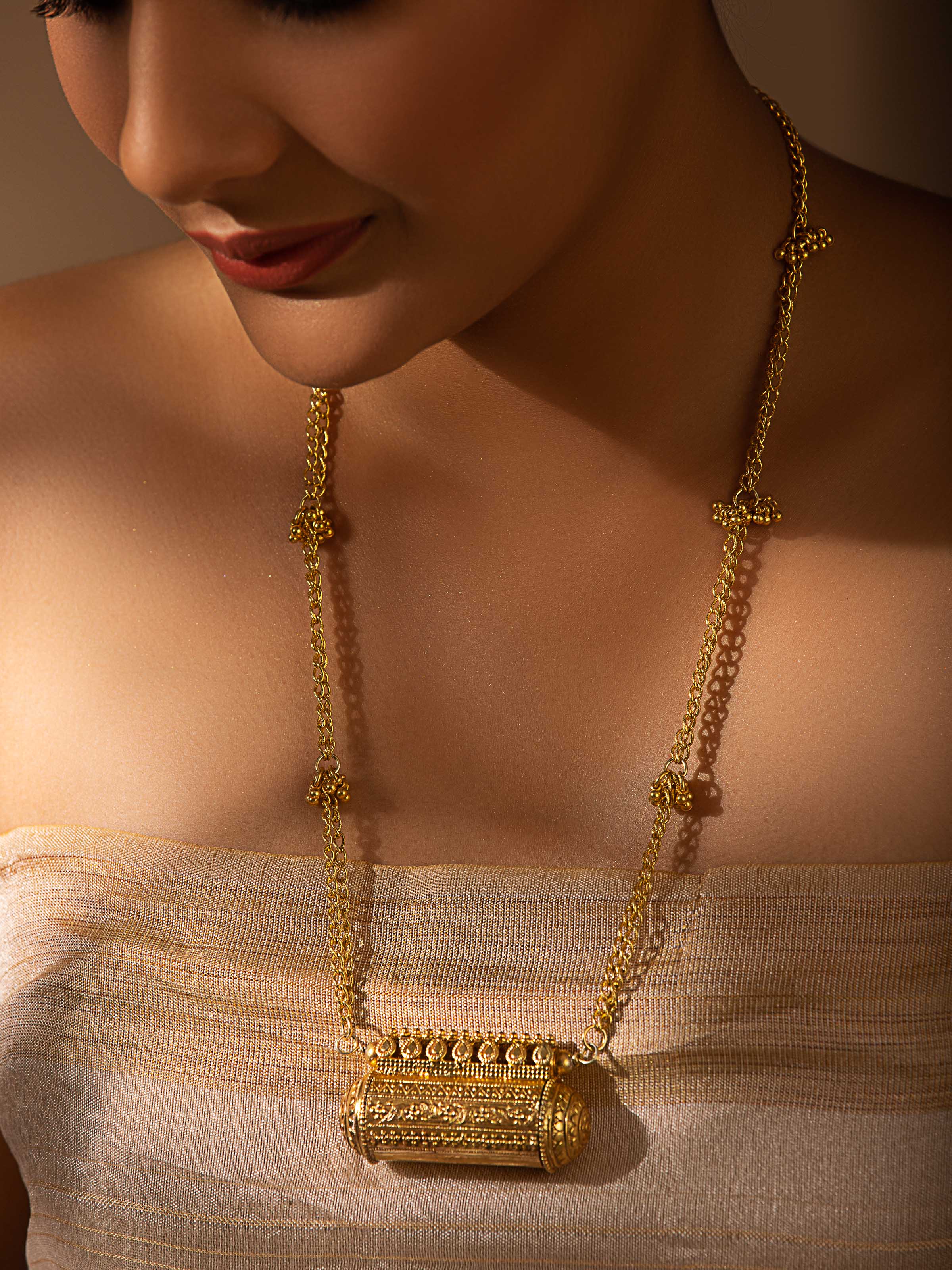 Side view of Silver Smithing long necklace highlighting its smooth finish and intricate design