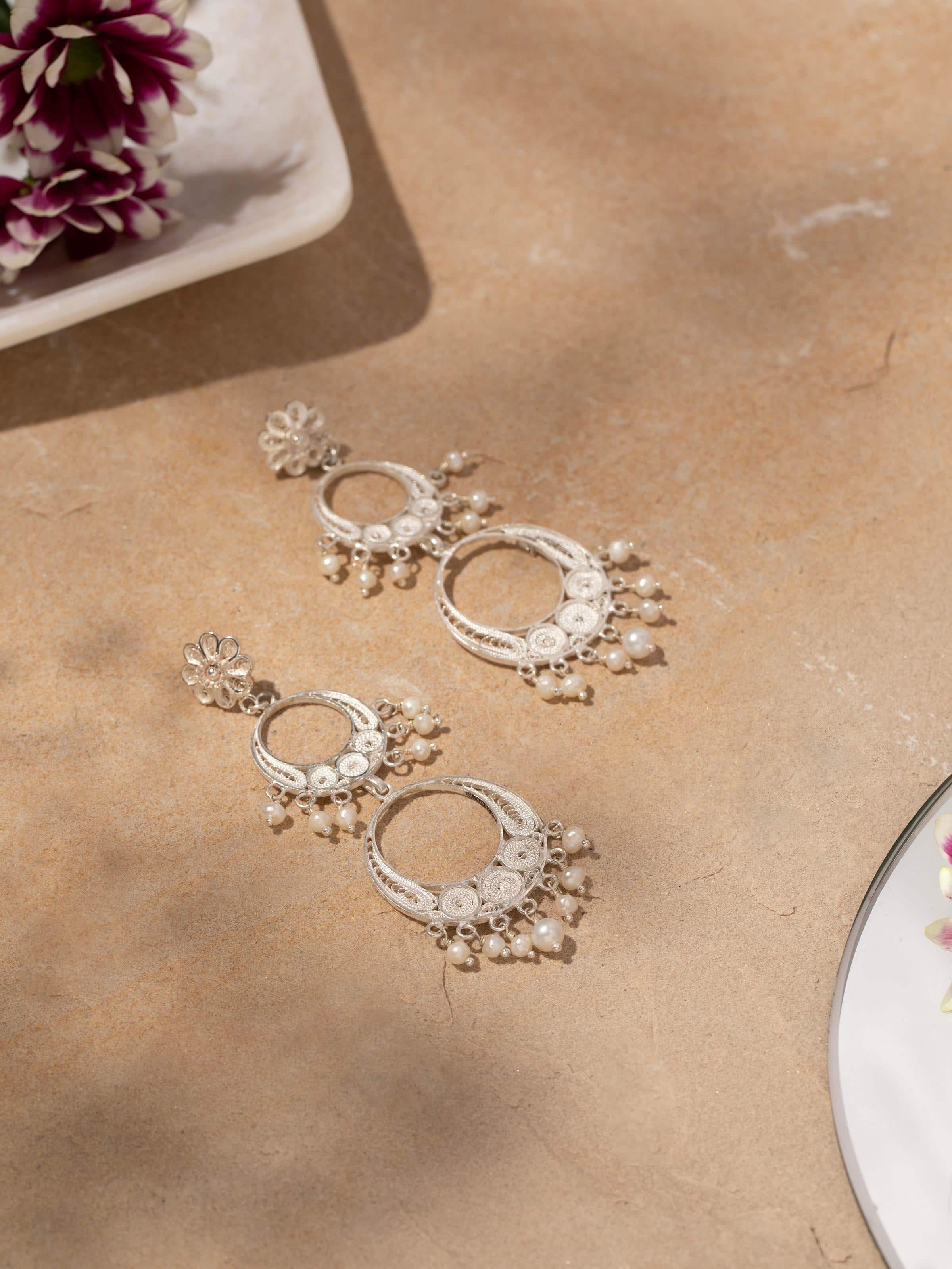 Side view of Silver filigree drop earrings highlighting detailed metalwork