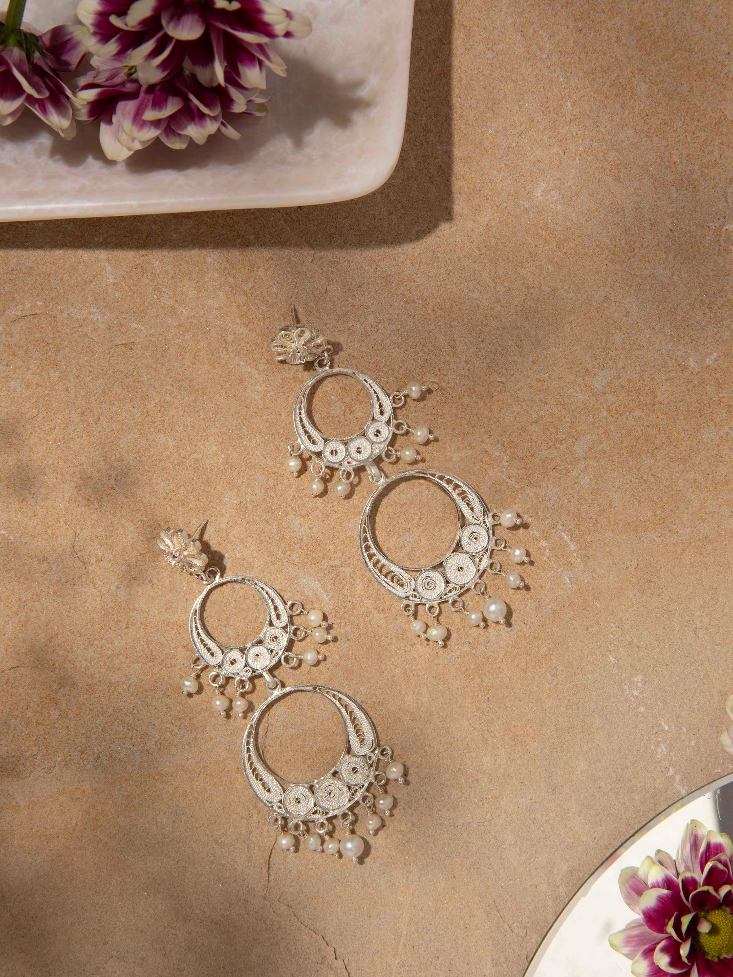 Close-up of Silver filigree drop earrings showing fine filigree patterns