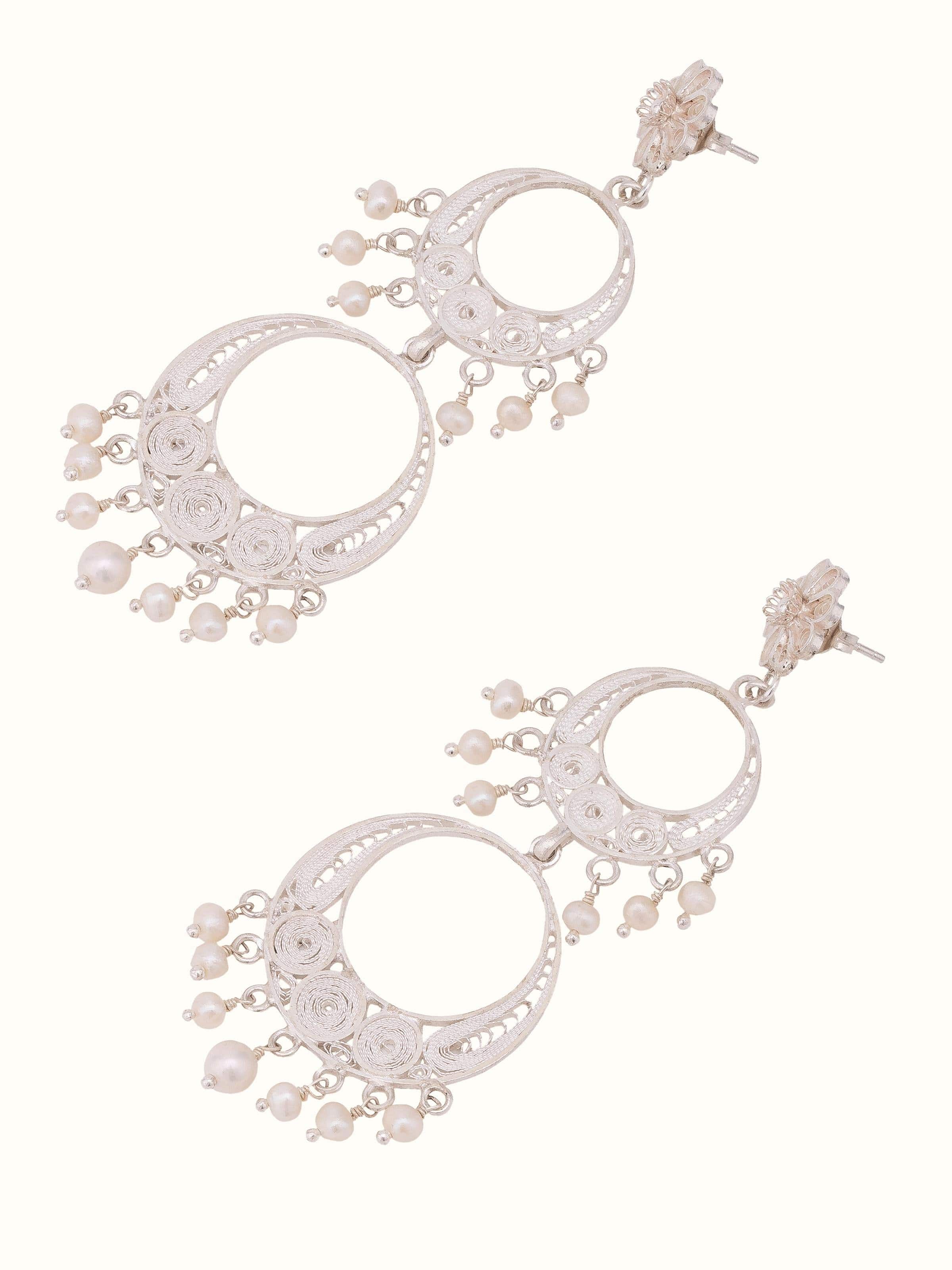 Angled view of Silver filigree drop earrings with elegant design details