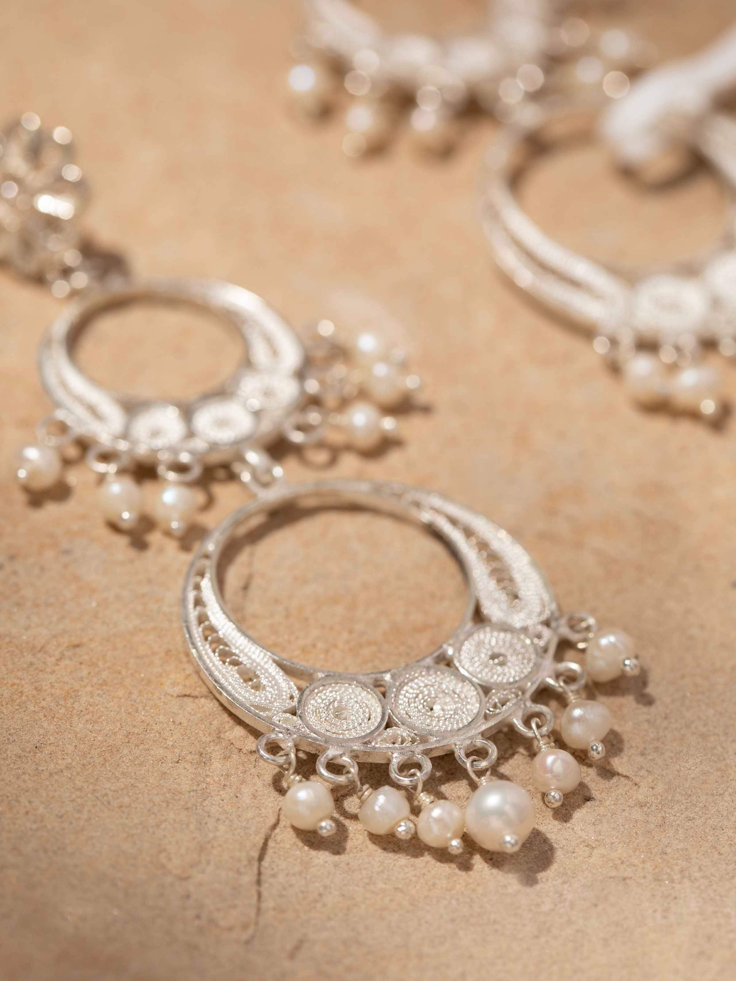 Detailed front view of Silver filigree drop earrings featuring ornate craftsmanship