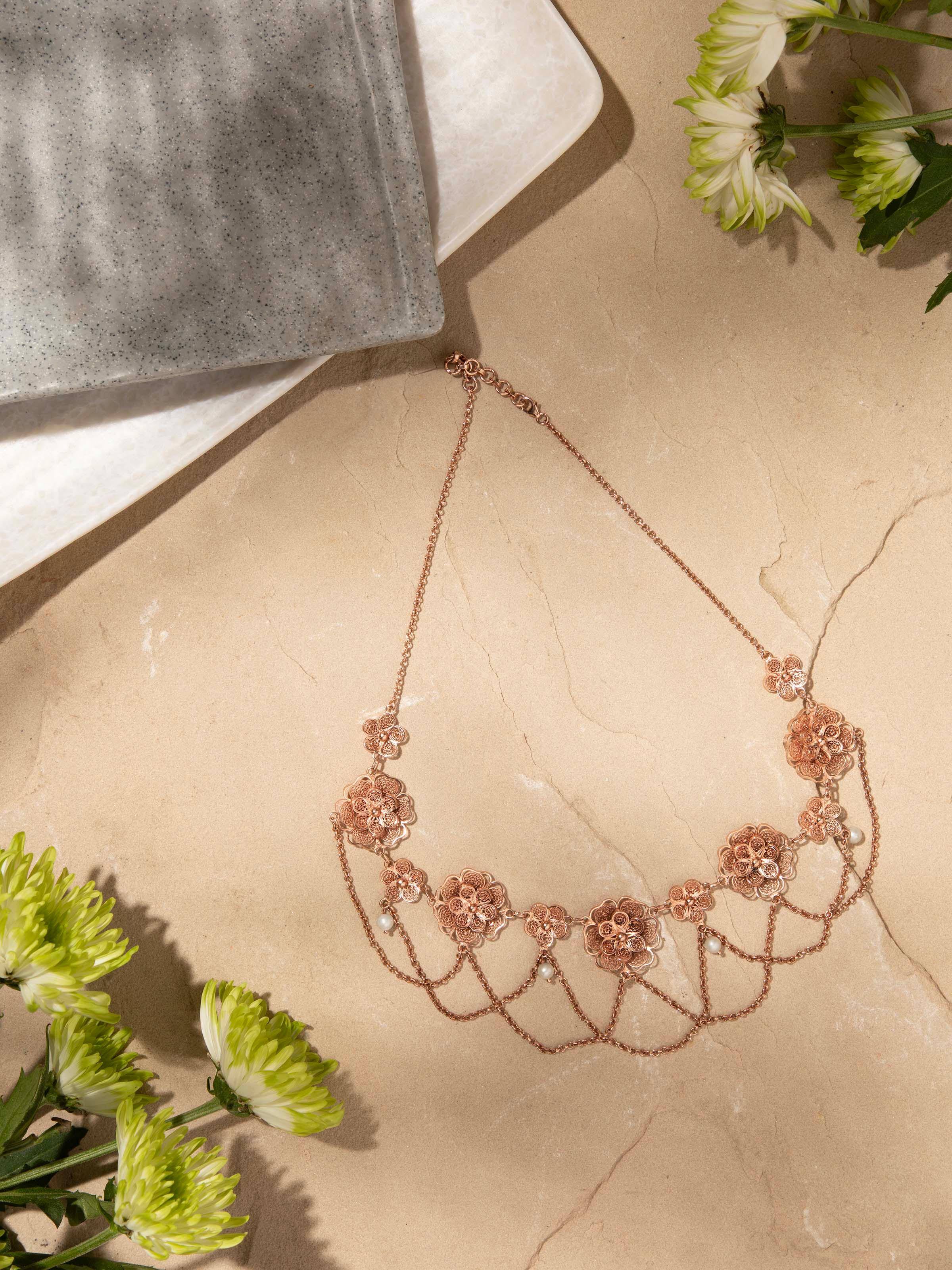 Angled view of silver filigree collar necklace showcasing the intricate metalwork.