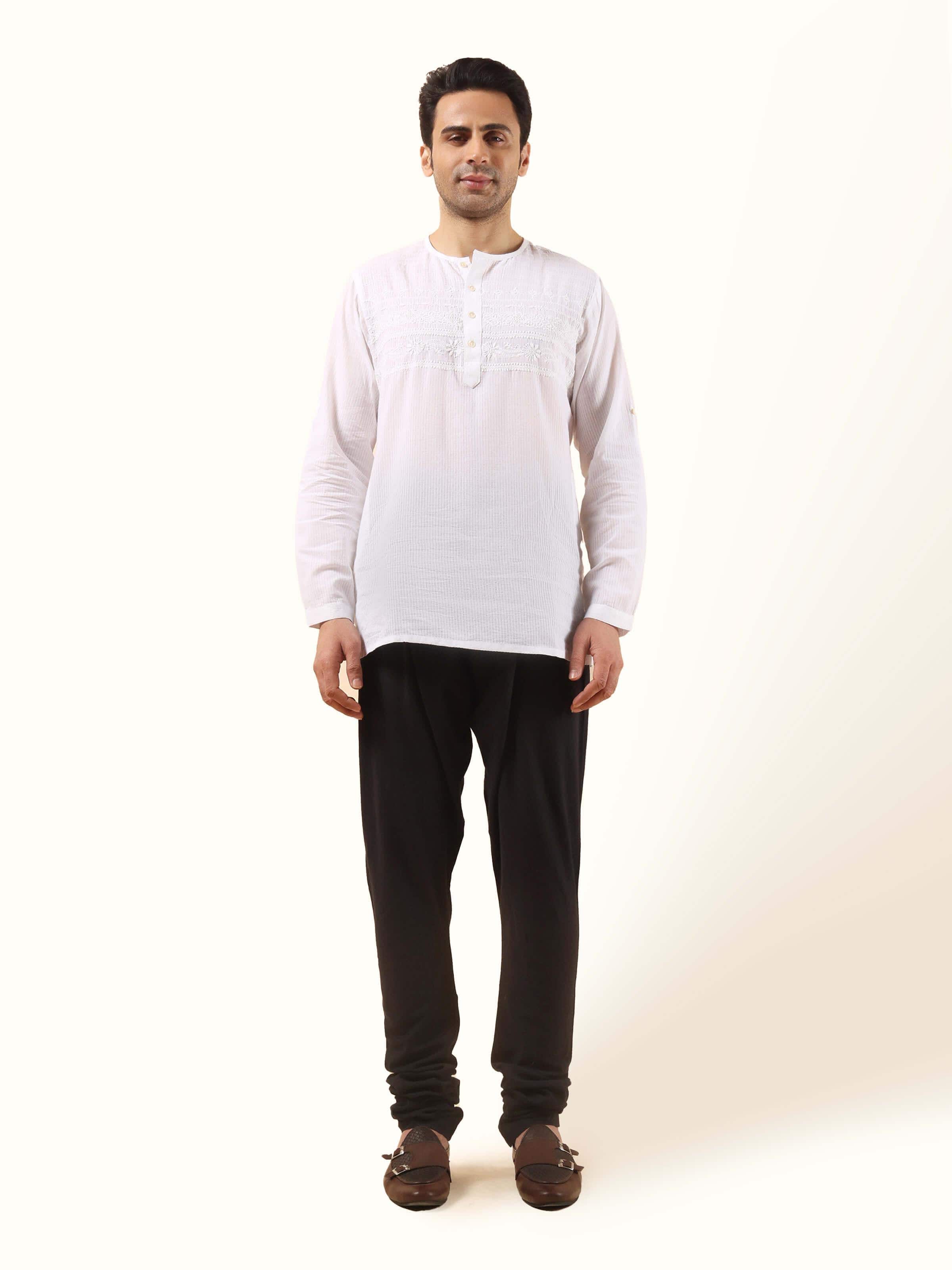 Front view of black cotton churidar with elasticated waist and tapered ankle fit.