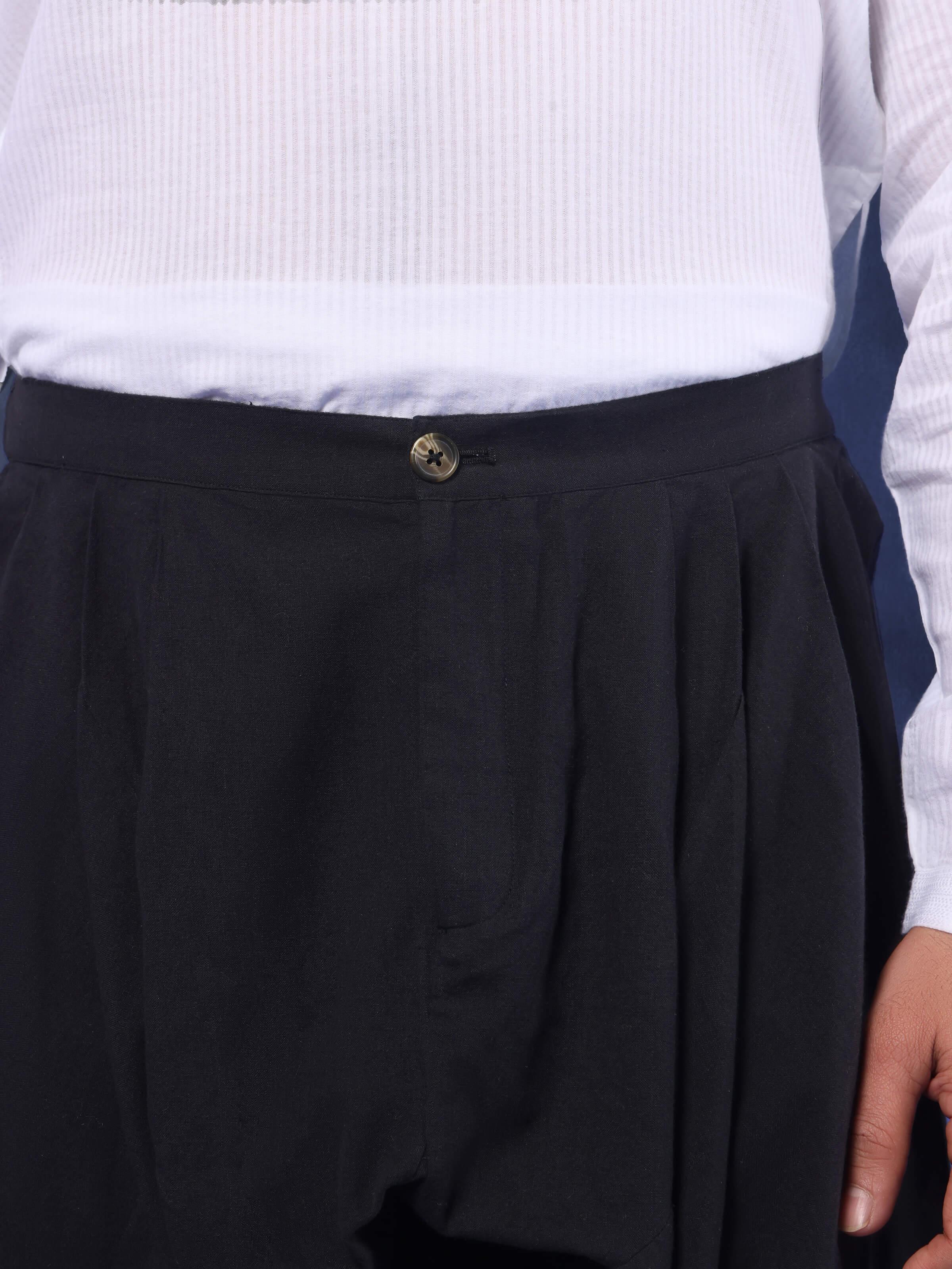 Close-up showing elasticated waistband and fine stitch of black churidar.