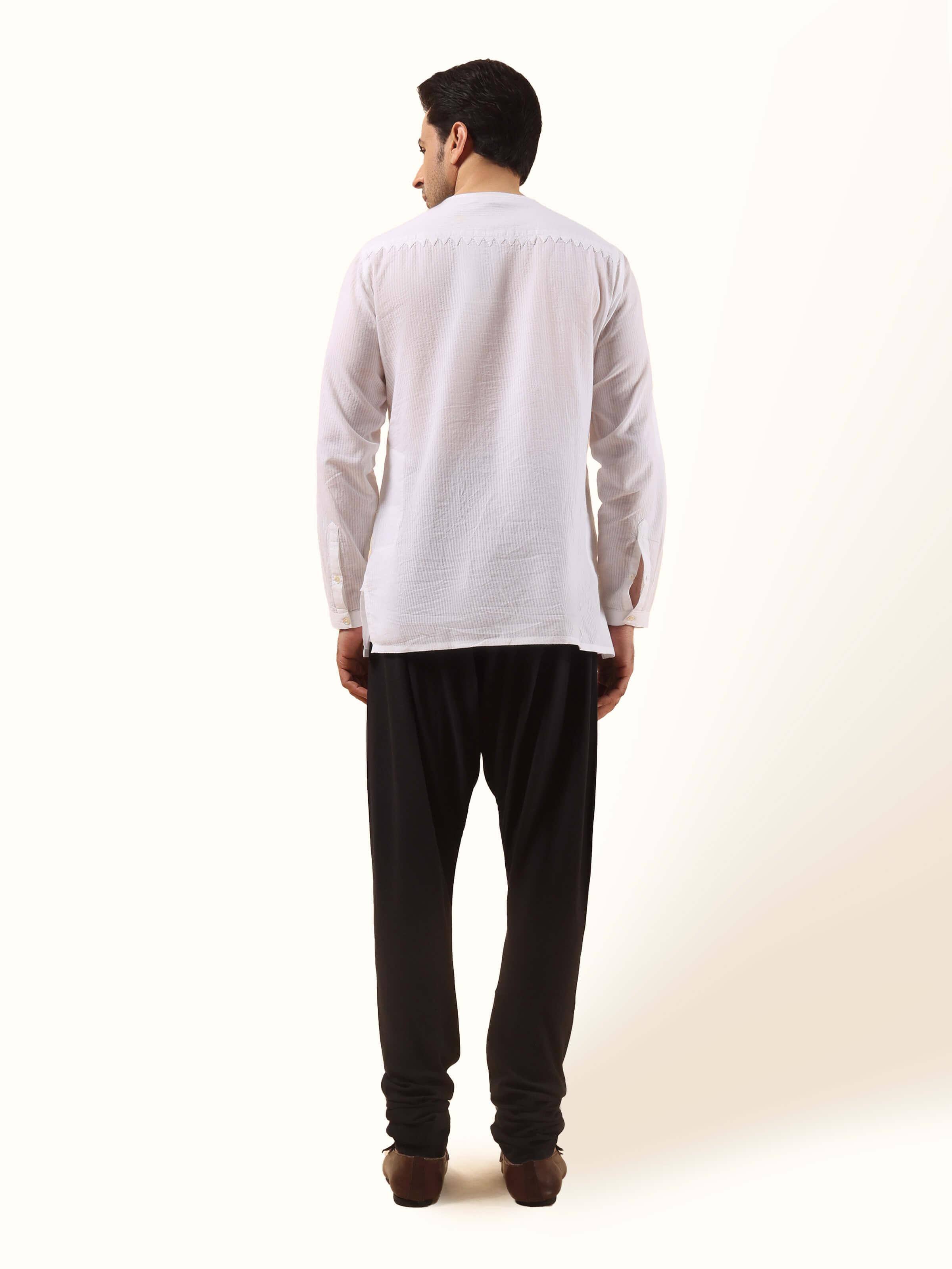 Back view of black churidar highlighting clean seam and body-contouring silhouette.