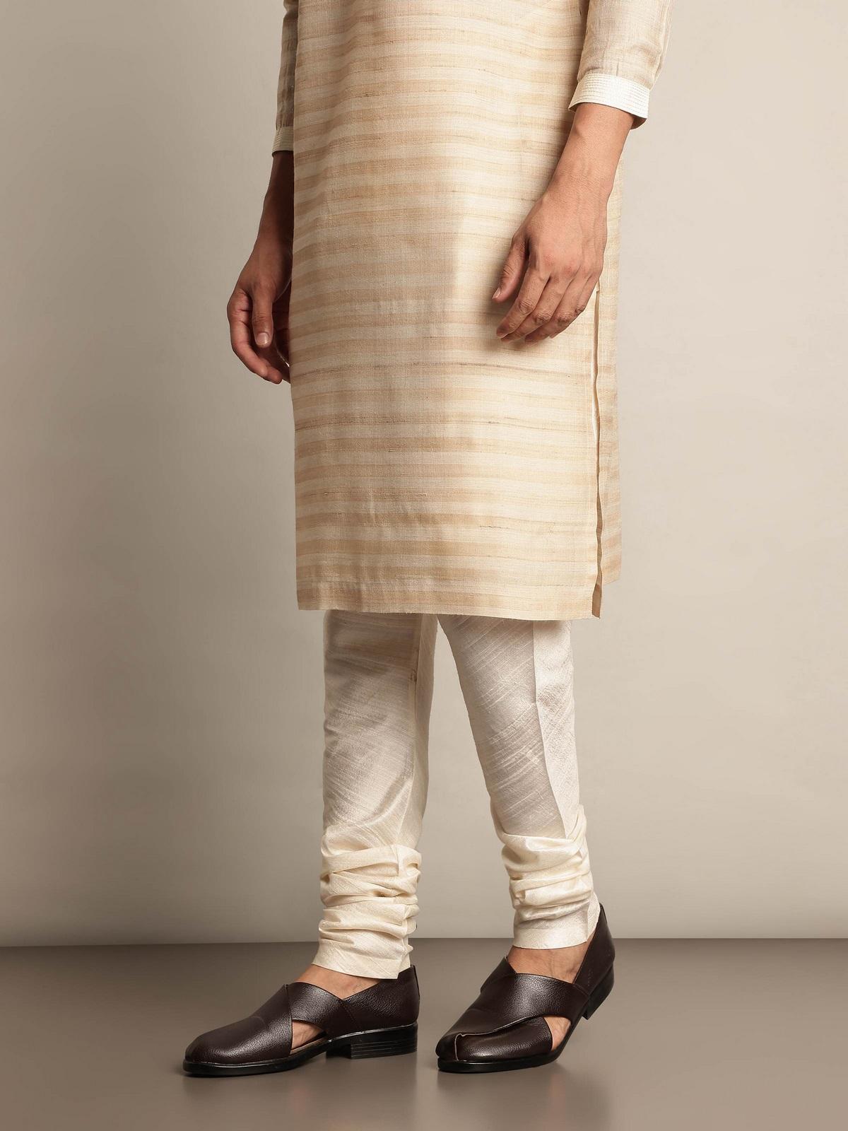 Angled view of white Bhagalpur silk elasticated churidar highlighting sleek design and comfort fit.