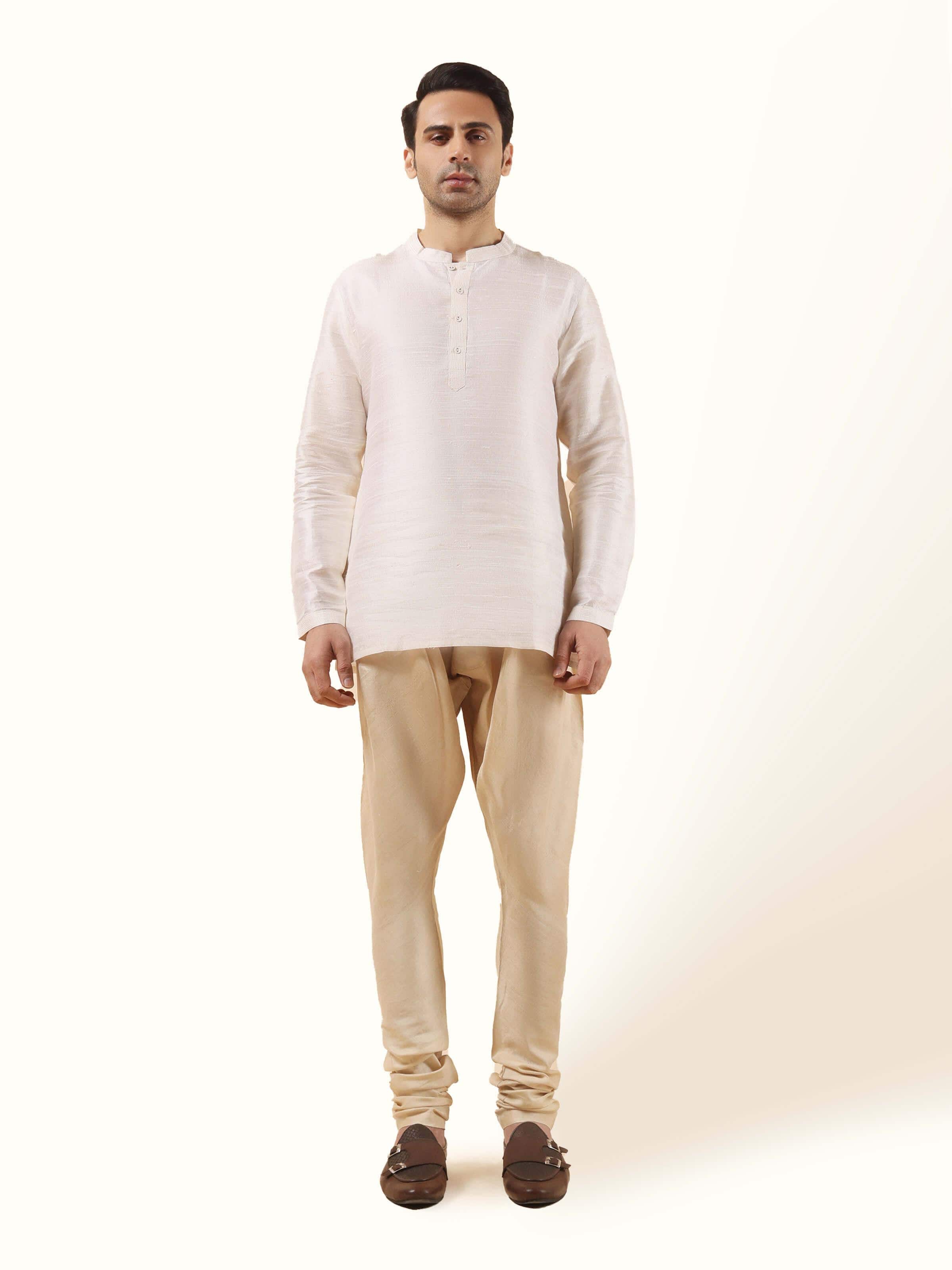 Front view of cream Tussar silk churidar with a soft sheen and elasticated waist.