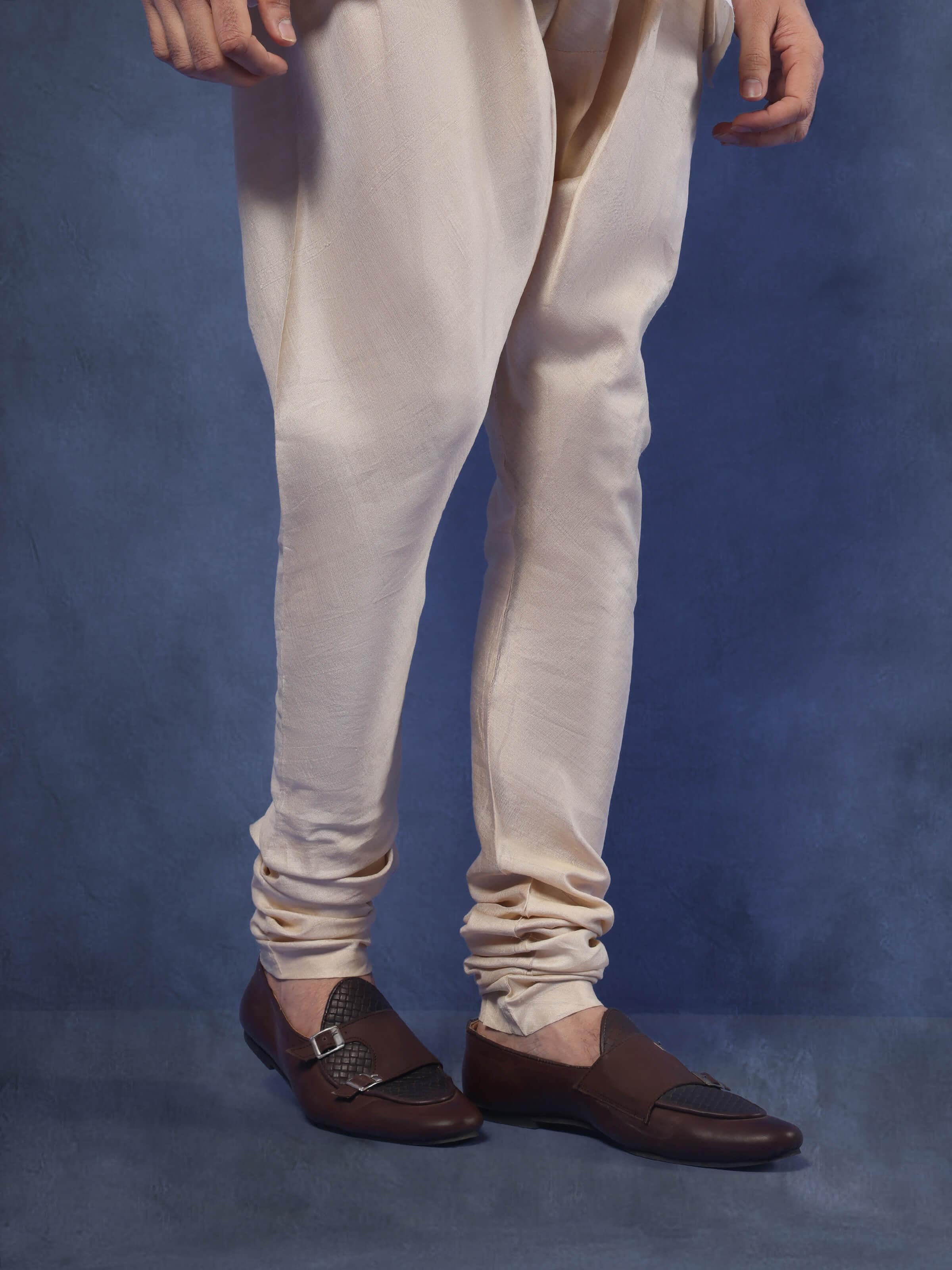 Angled view capturing the fit and natural drape of the Tussar silk churidar.