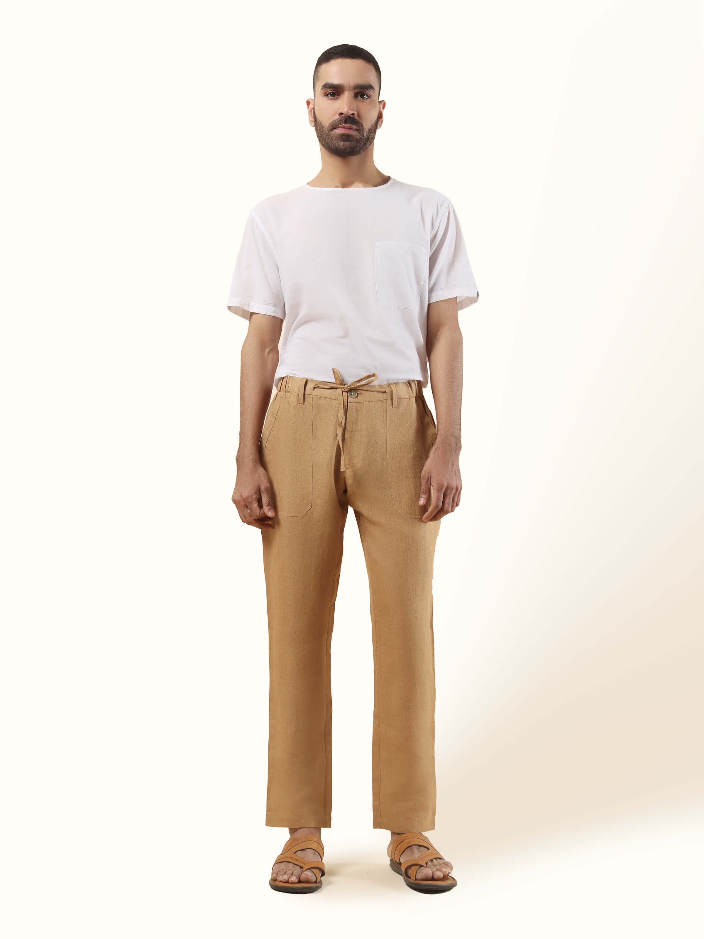 Front view of beige linen lounge pant with elasticated waist and straight-leg relaxed silhouette