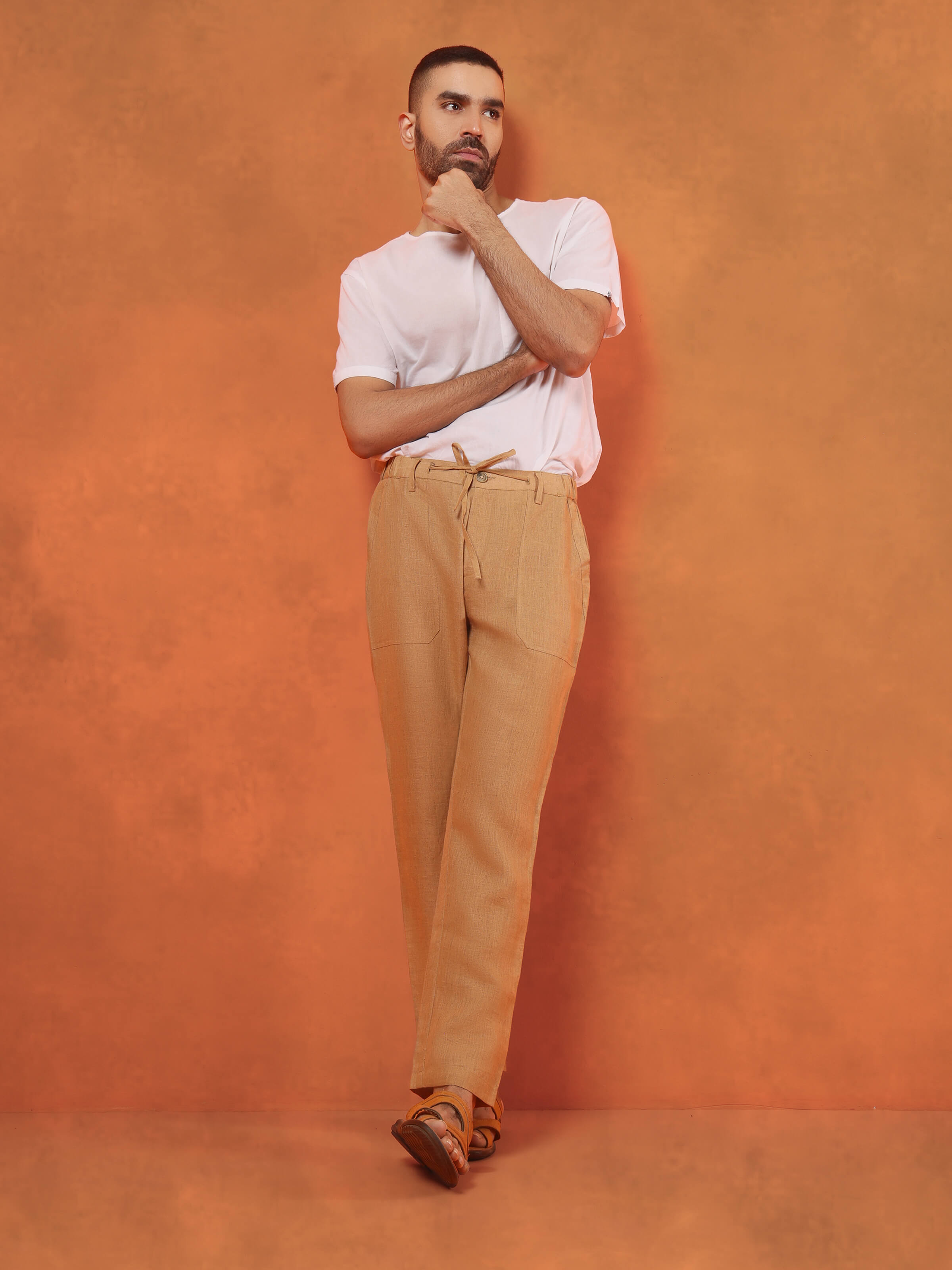 Lifestyle view of beige linen lounge pant styled for casual summer comfort with light layering