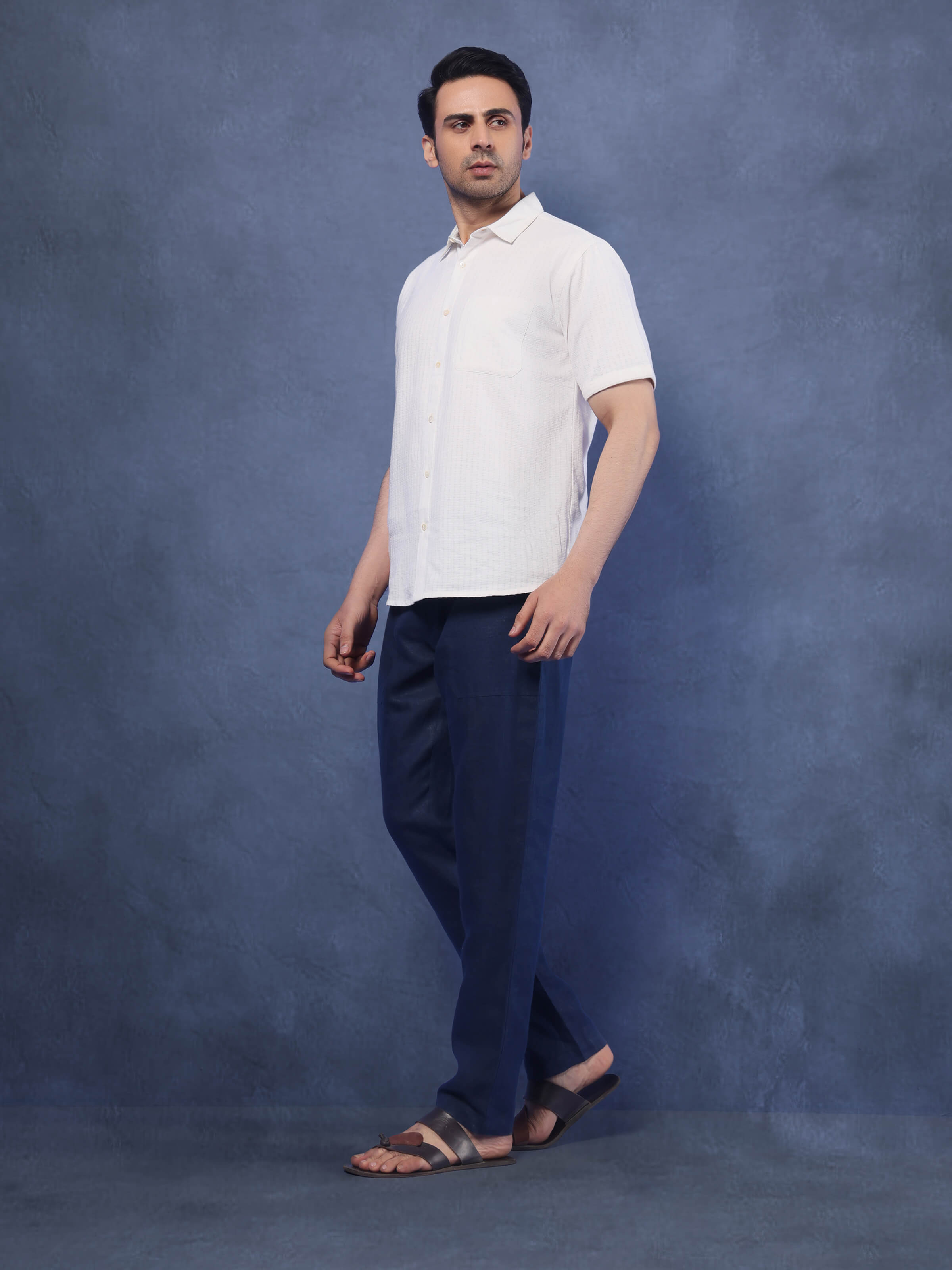 Lifestyle view of navy blue linen elasticated pant styled casually, showcasing fit and natural drape of the linen fabric.