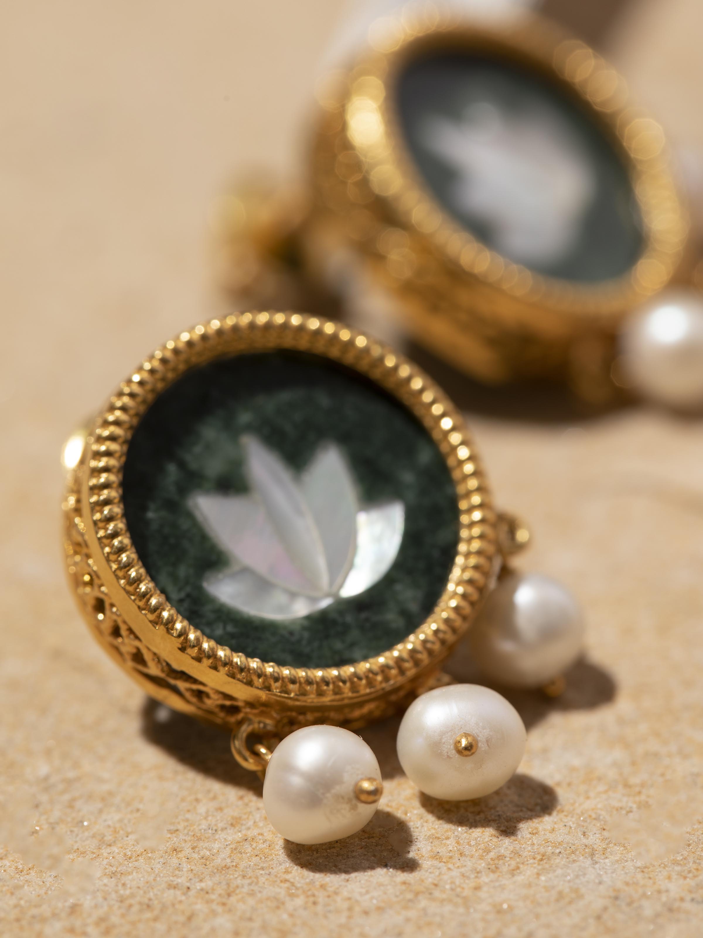 Detail shot of Parchinkari drop earrings revealing intricate artistry and floral motif work.