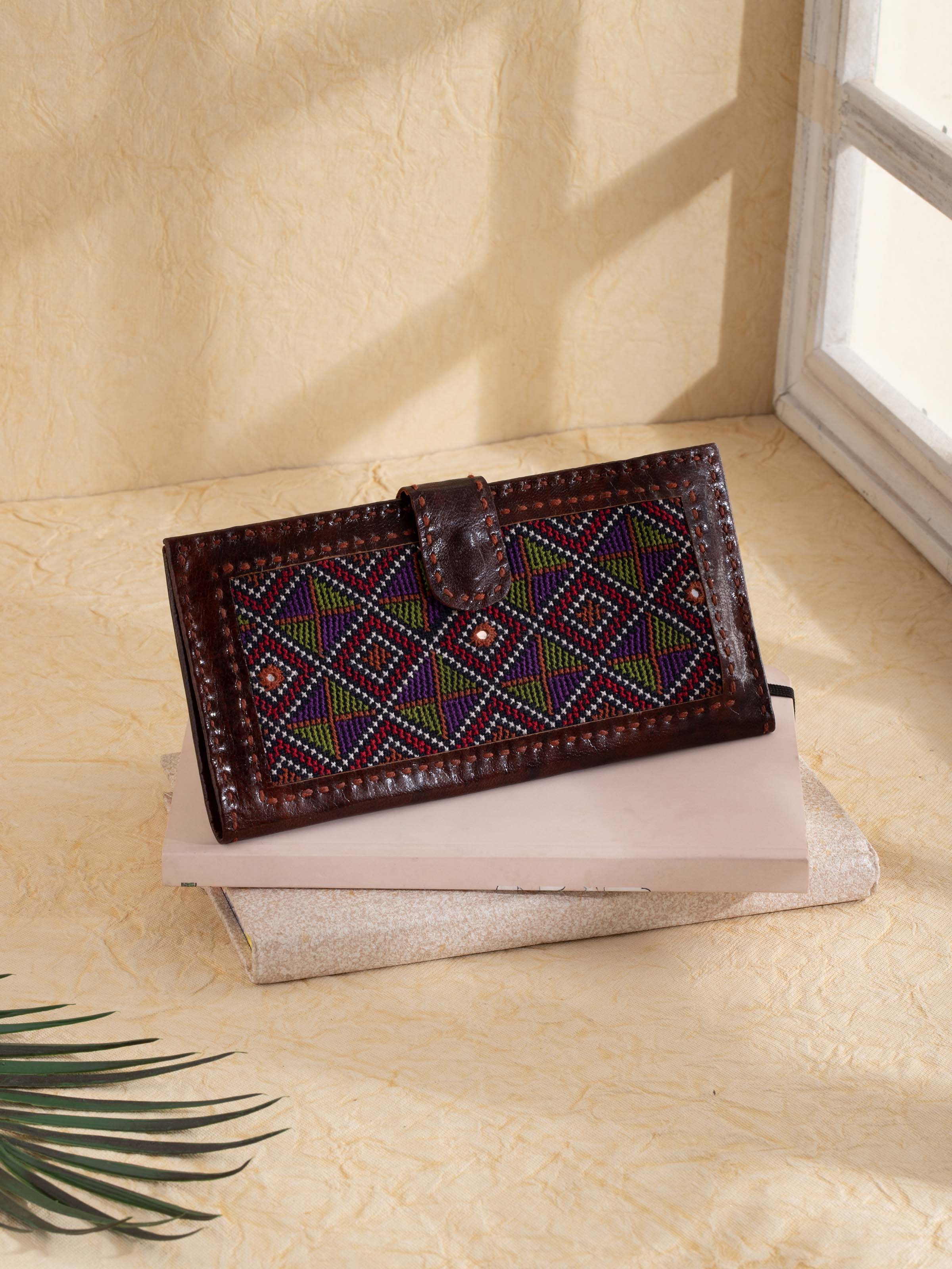 Side view of Kutchi leather embroidered clutch focusing on embroidery details and design