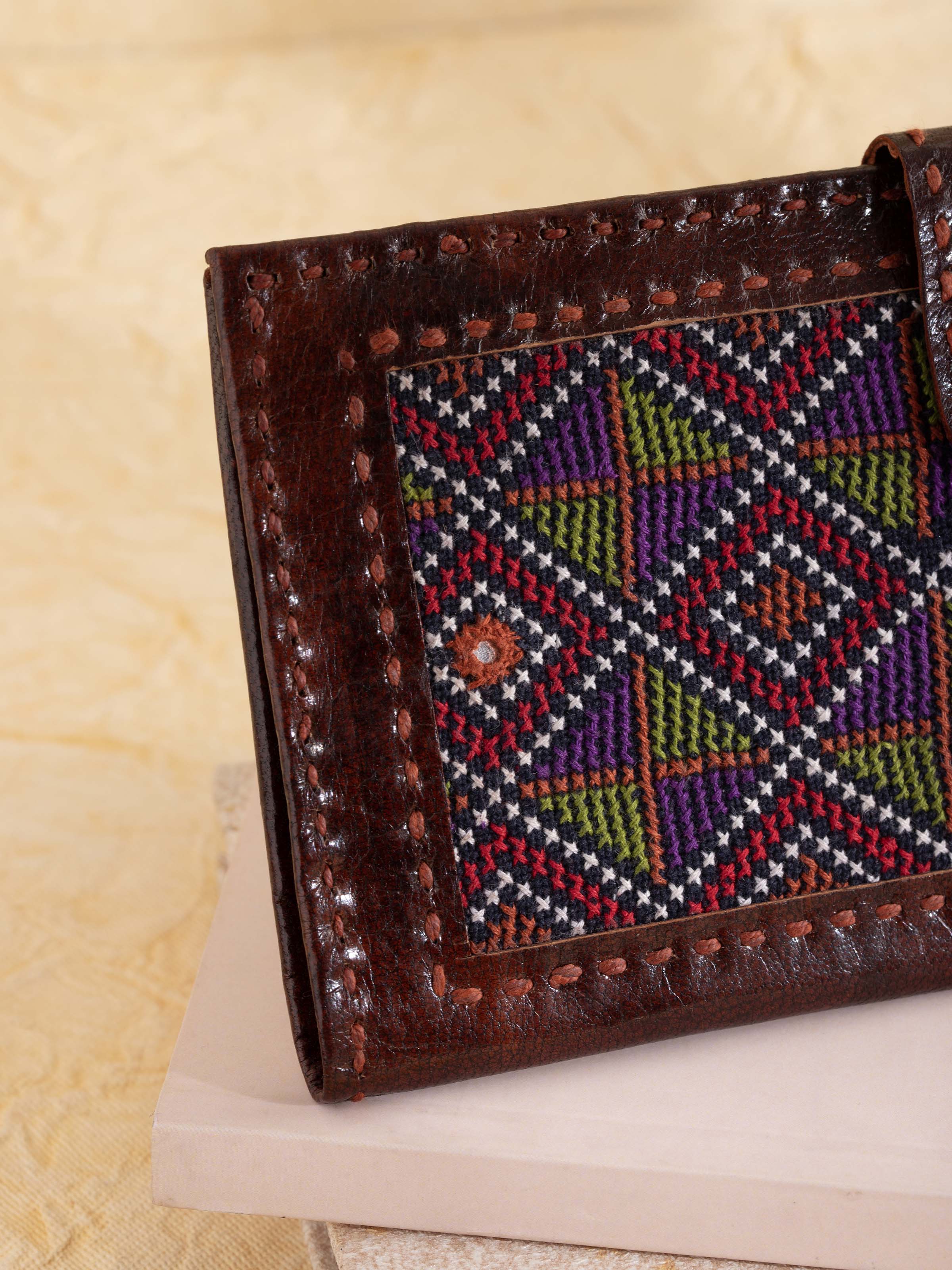 Close-up of Kutchi leather embroidered clutch highlighting intricate embroidery and craftsmanship
