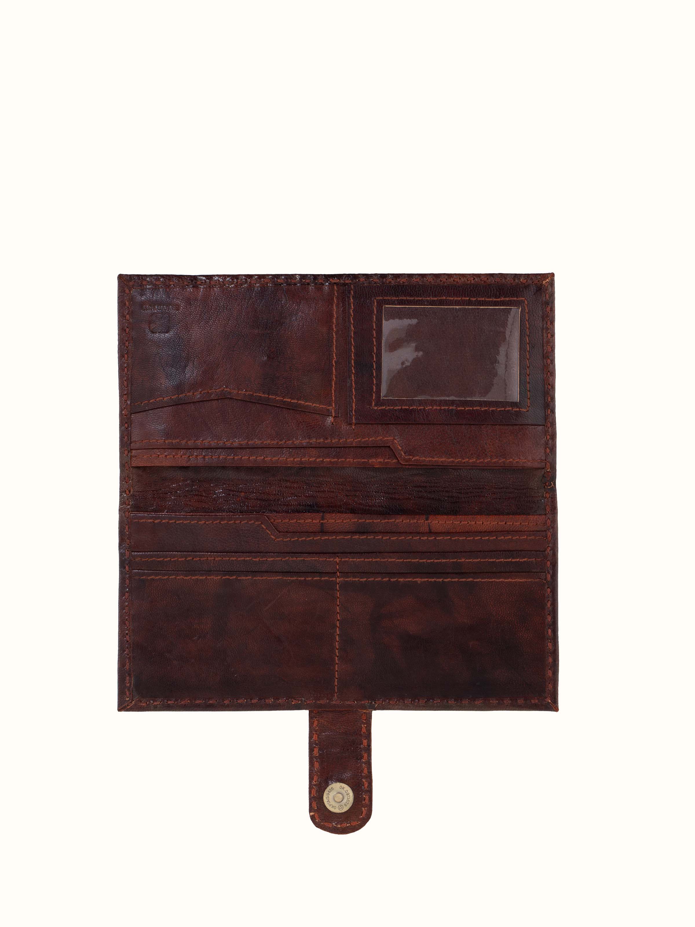 Angled view of Kutchi leather embroidered clutch emphasizing design and texture