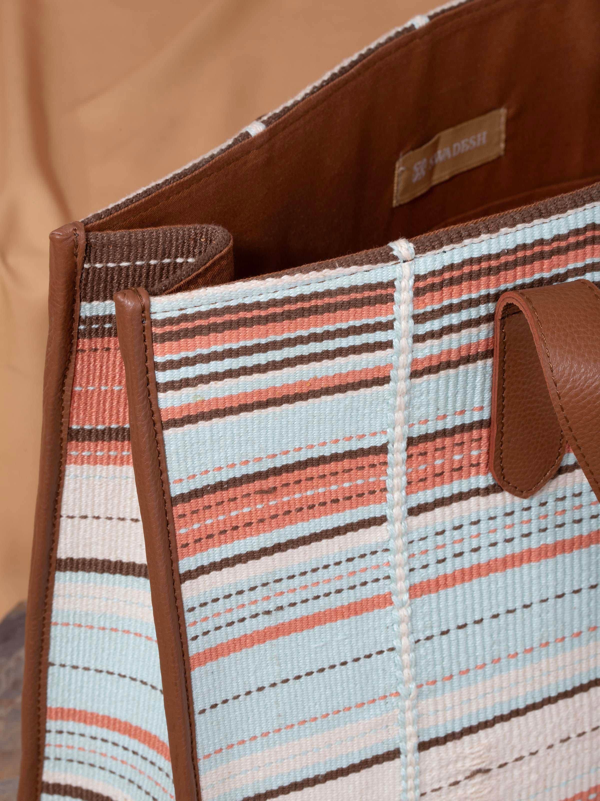 Close-up of multicolor leather & textile Nagaland loin loom tote bag focusing on textile patterns and leather quality