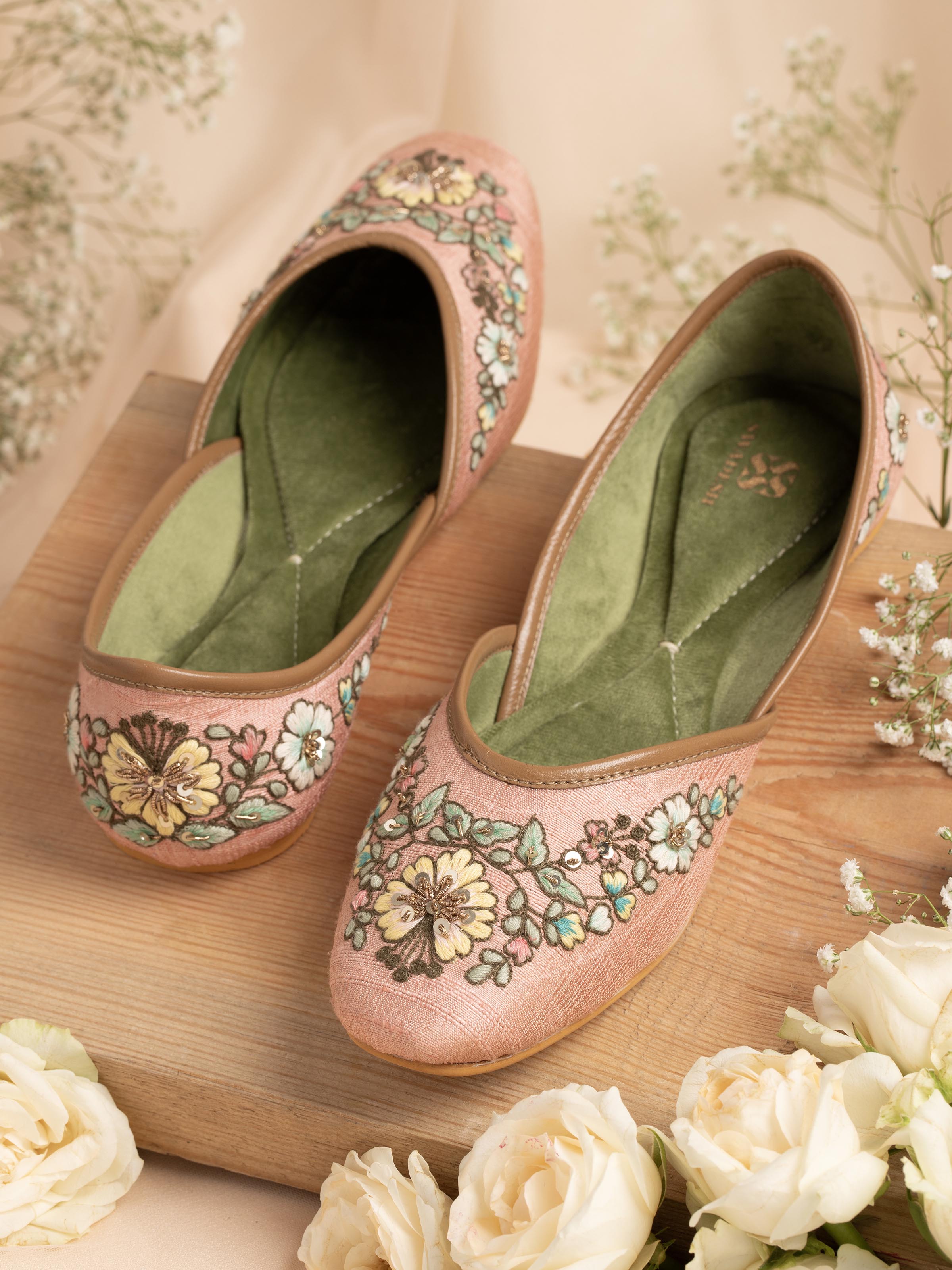 Side view of pink leather zardozi juttis highlighting the detailed craftsmanship