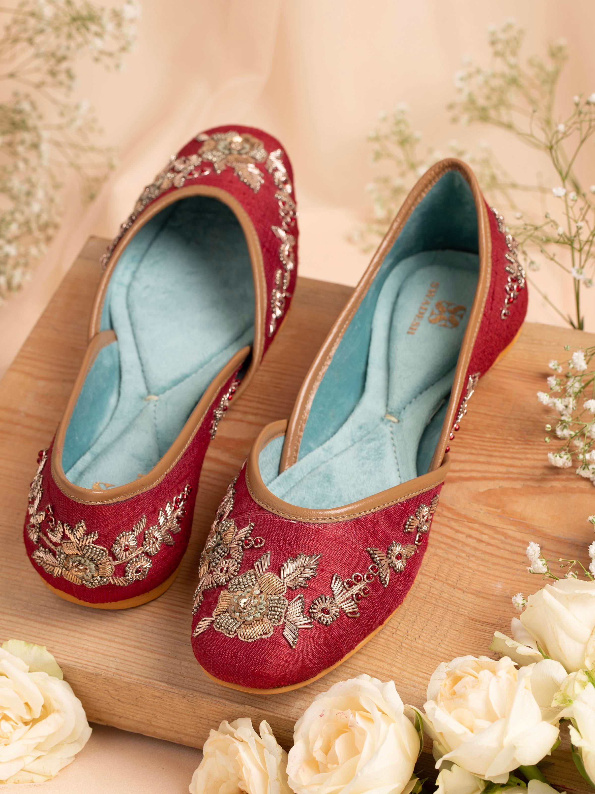 Side view of maroon leather zardozi juttis highlighting the embroidery and profile