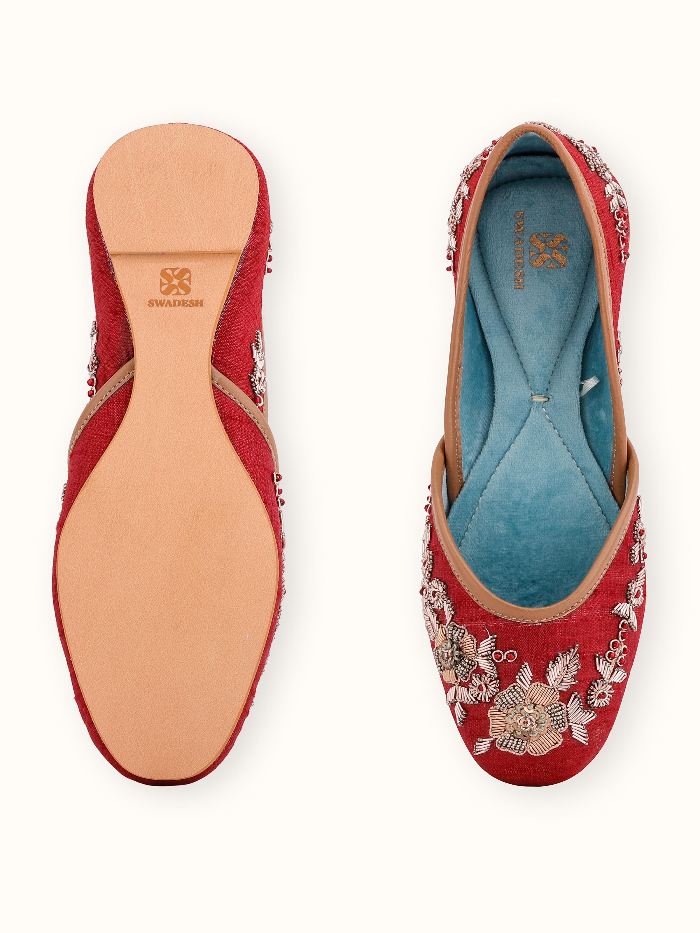 Back view of maroon leather zardozi juttis displaying the heel and overall design