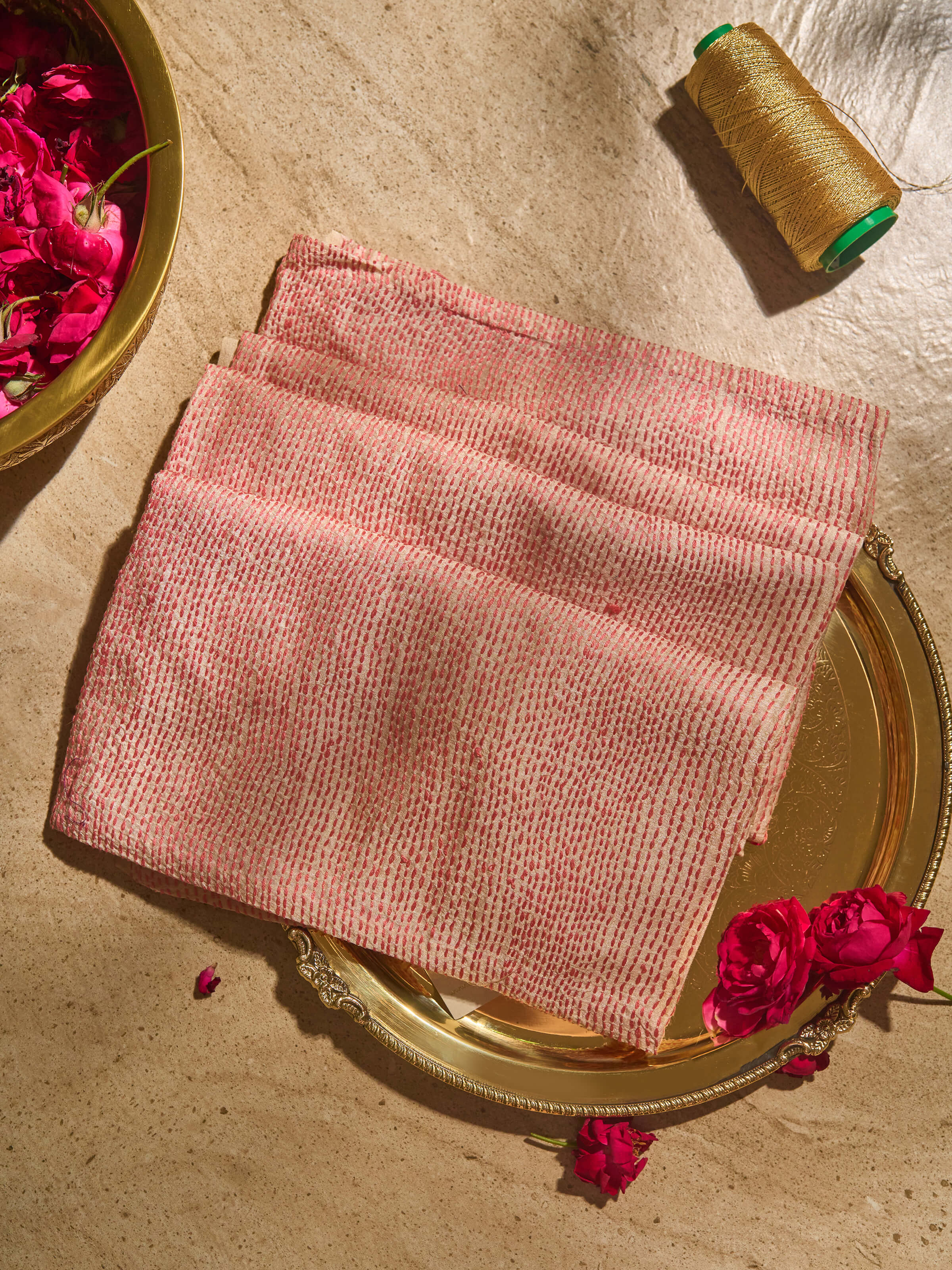 Close-up of detailed Sujani embroidery patterns on off-white tussar silk fabric blouse piece.