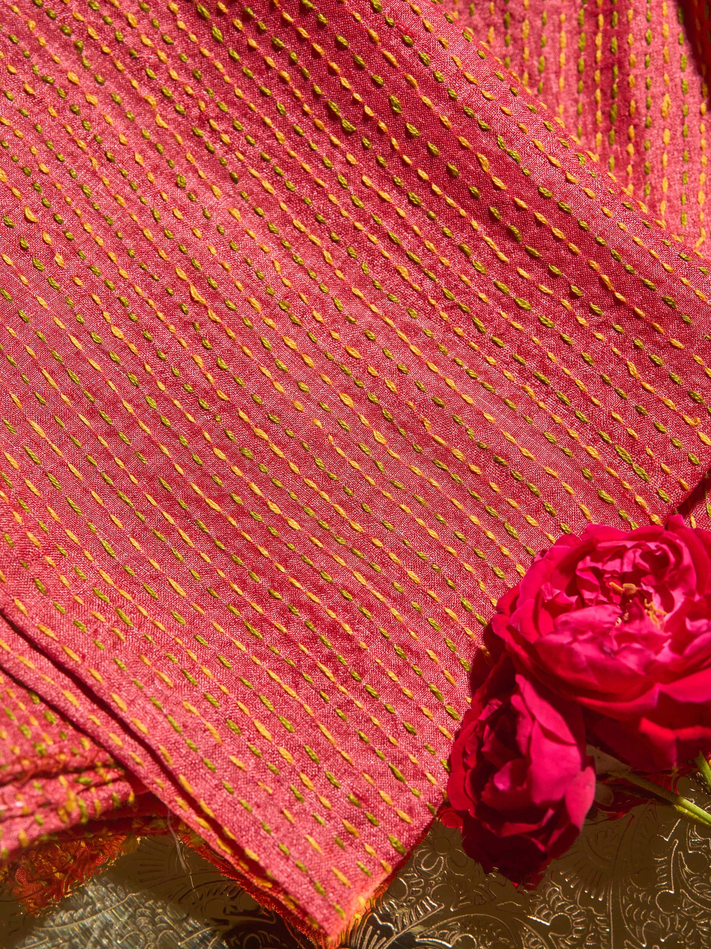 Diagonal view highlighting the sleeve and neckline embroidery.