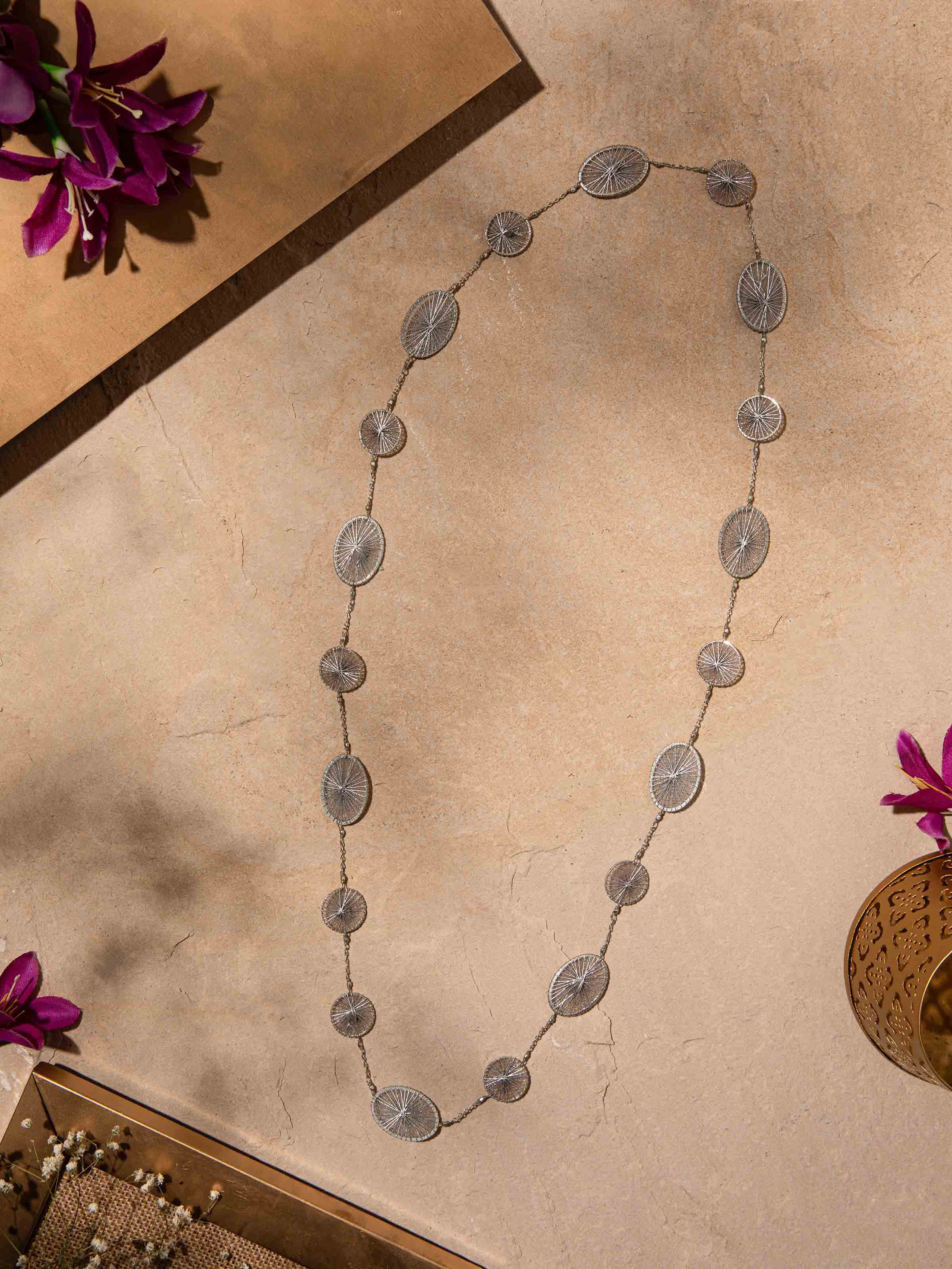 Close-up of String Craft Long Necklace showcasing the detailed string work and vibrant color patterns.