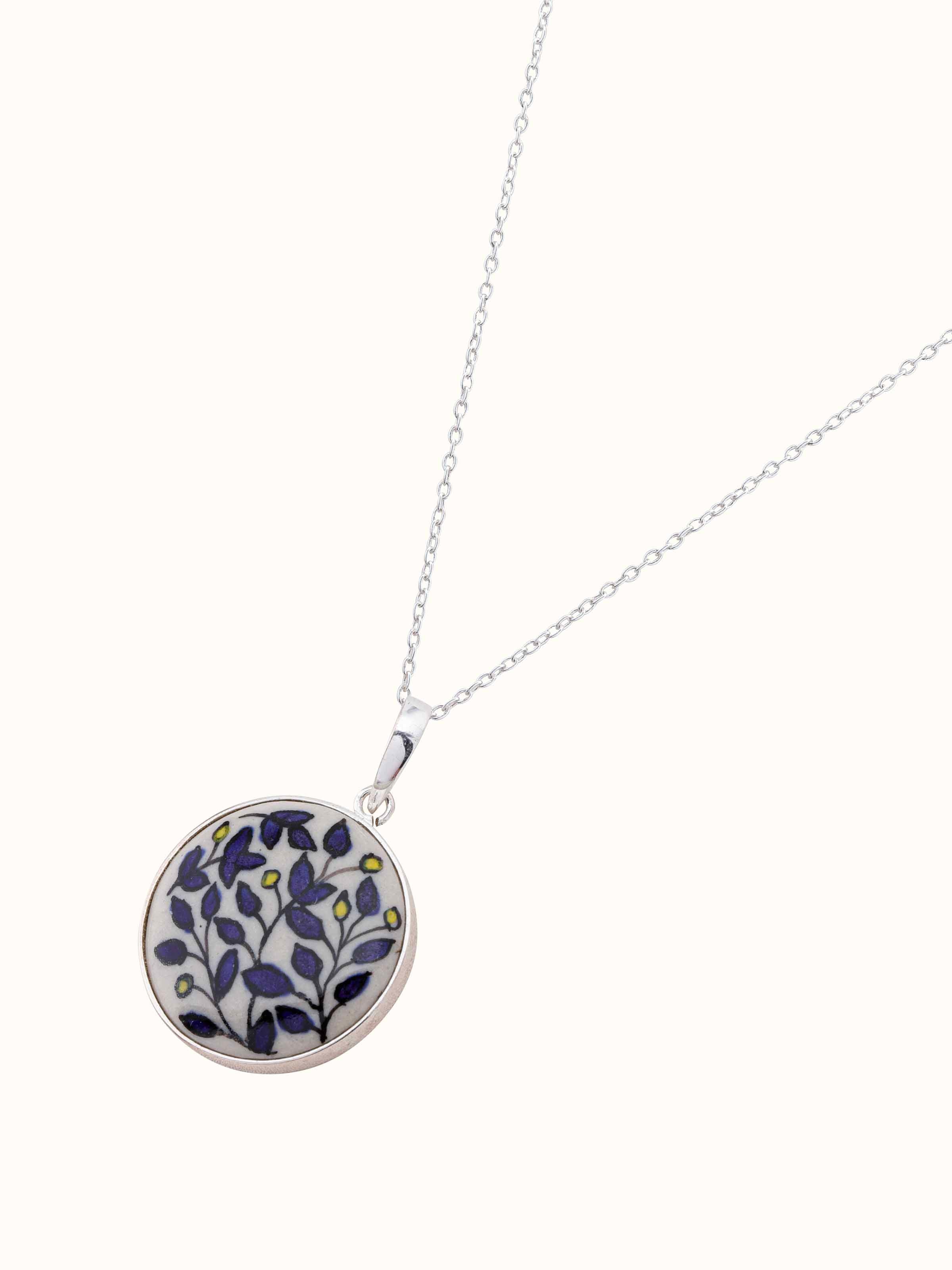Overhead view of ceramic pendant & chain emphasizing unique design and finish