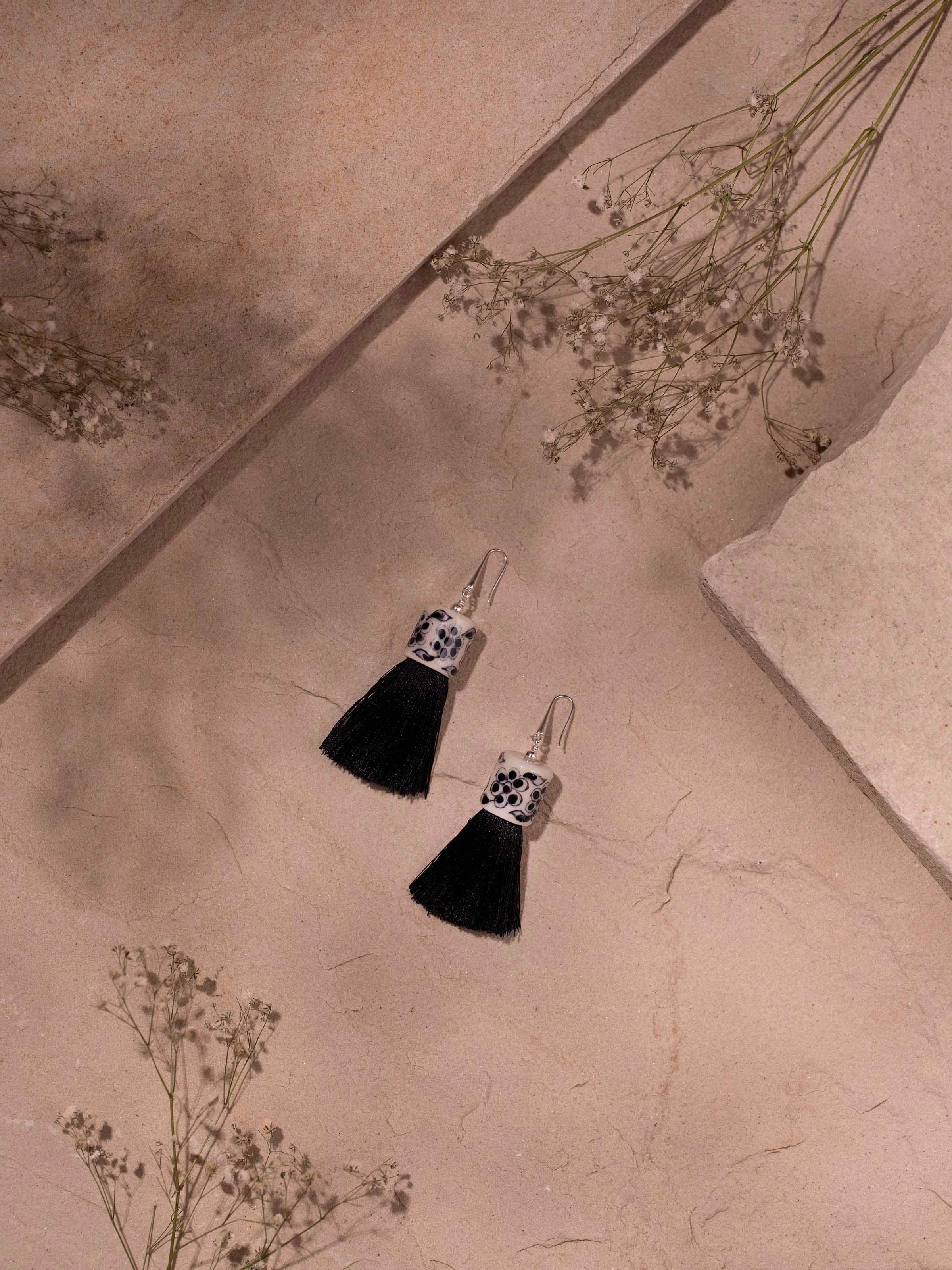 Close-up view of Ceramic Drop Earrings revealing the smooth ceramic surface and refined details.