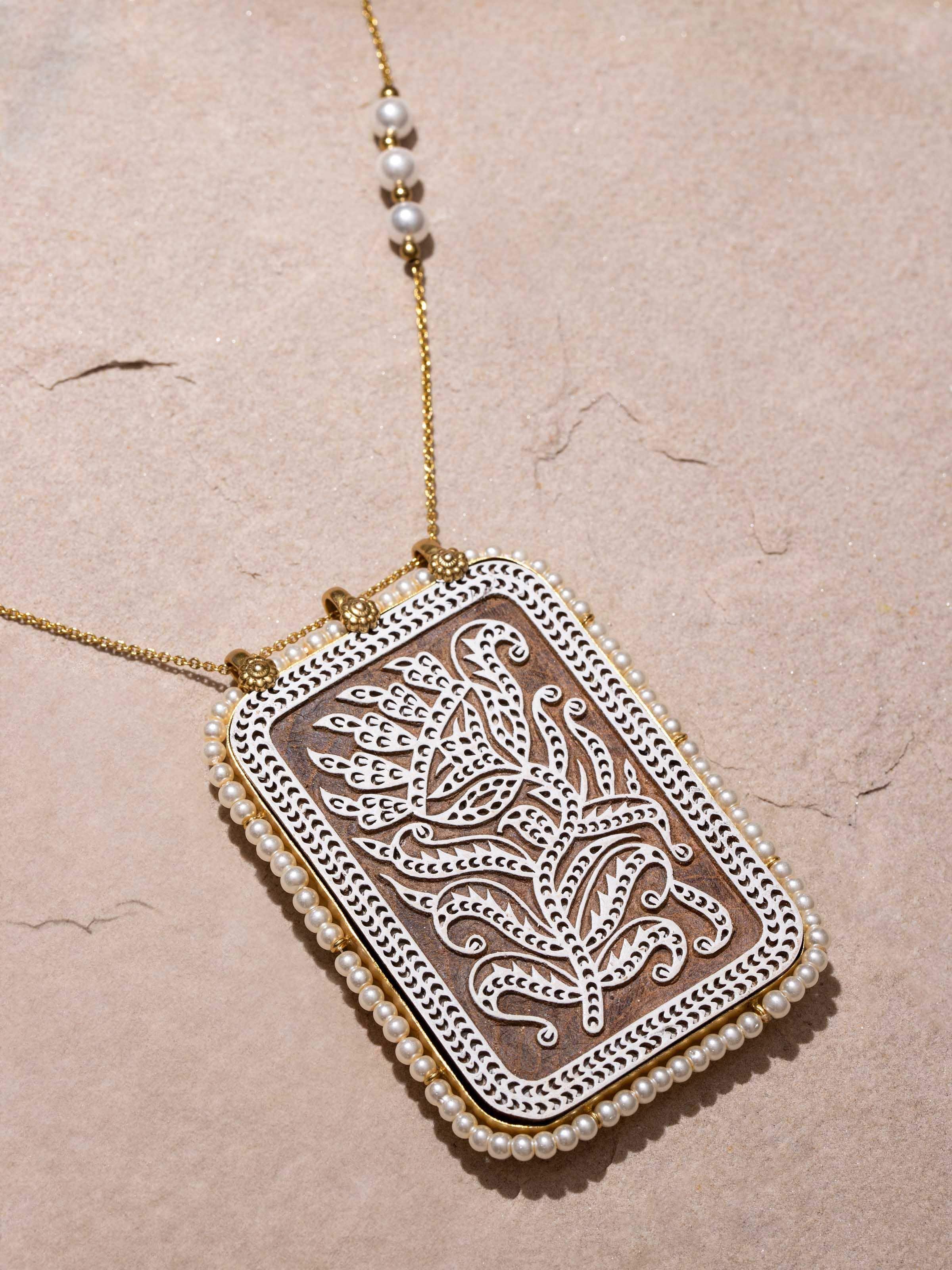 Angled view of Wood Block Carving Long Necklace showcasing its intricate carvings and elegant design.