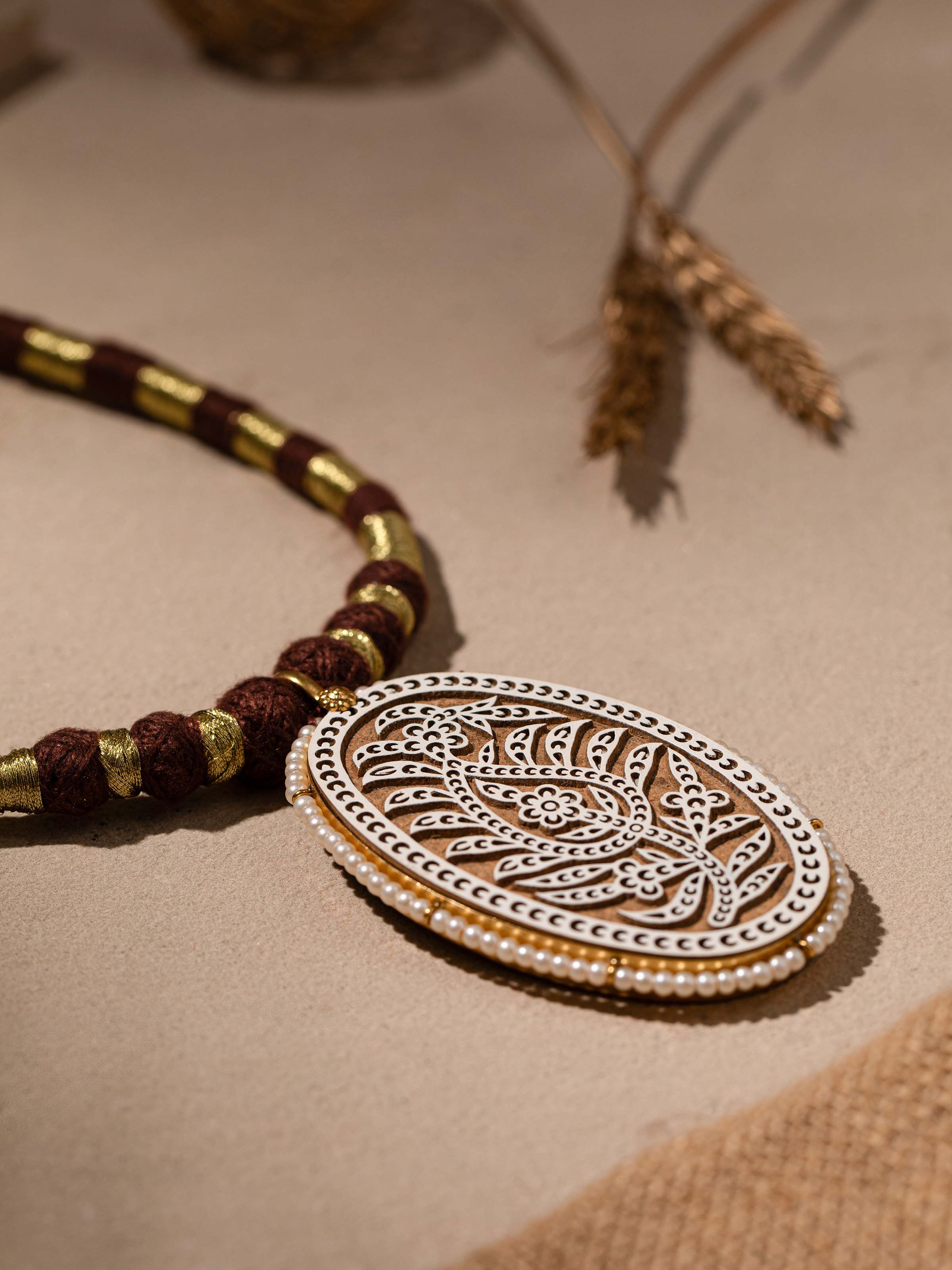 Side view of wood block carving collar necklace highlighting the detailed craftsmanship.