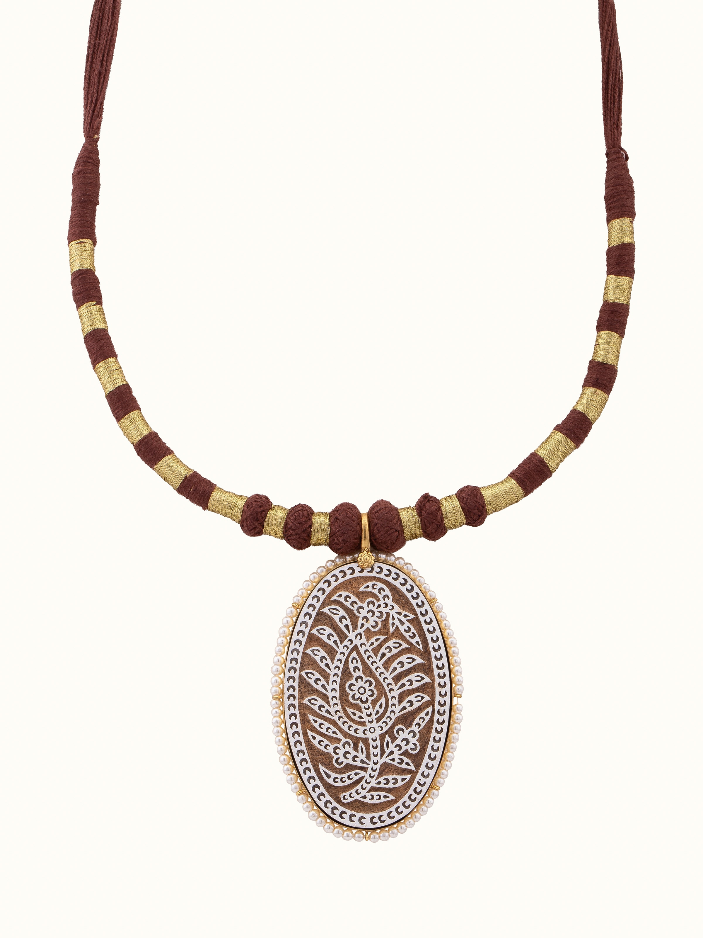 over view of wood block carving collar necklace emphasizing the intricate carvings.