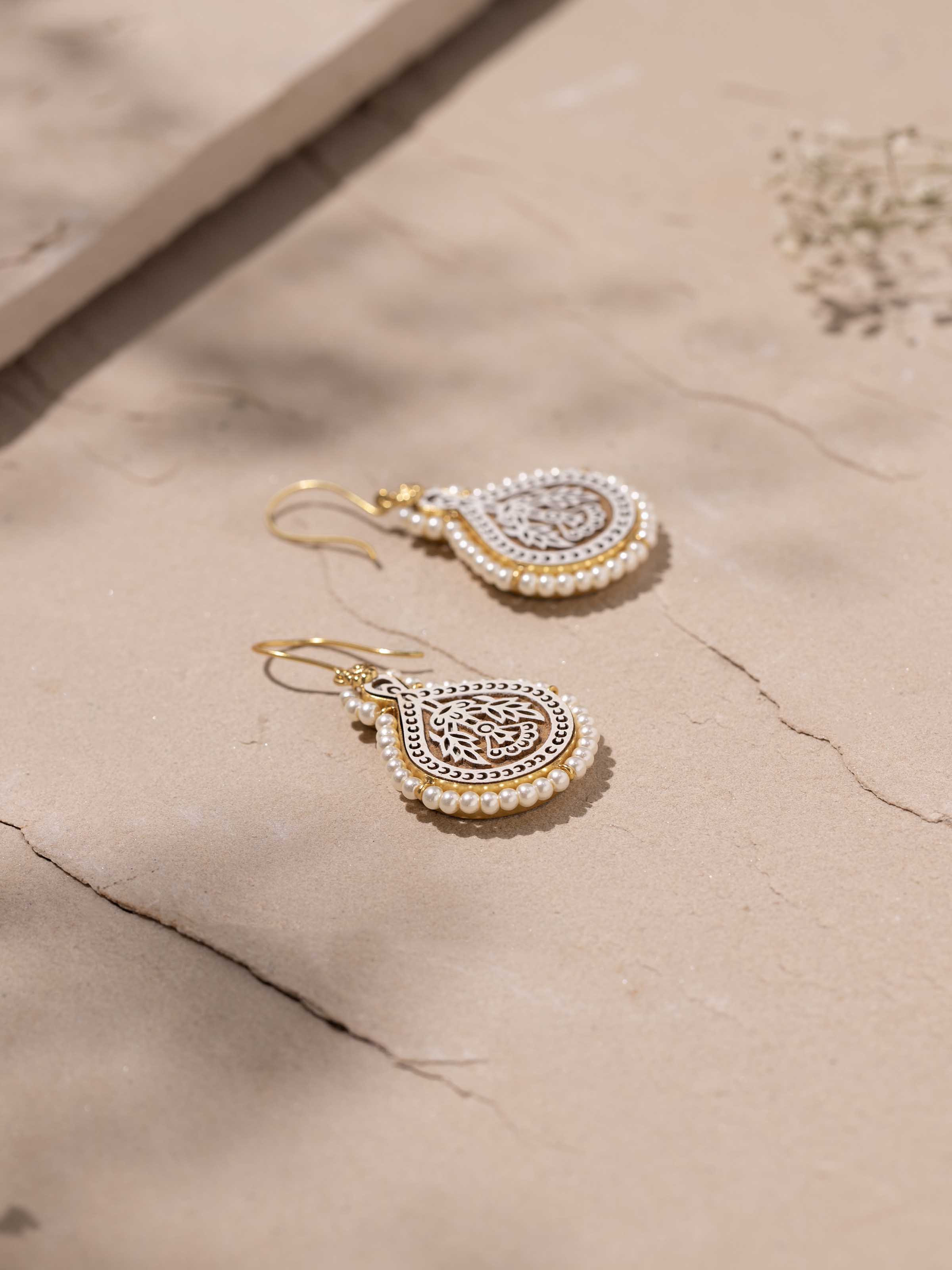 Overhead view of Wood Block Carving Drop Pair Earrings highlighting the intricate wooden carvings and drop design.