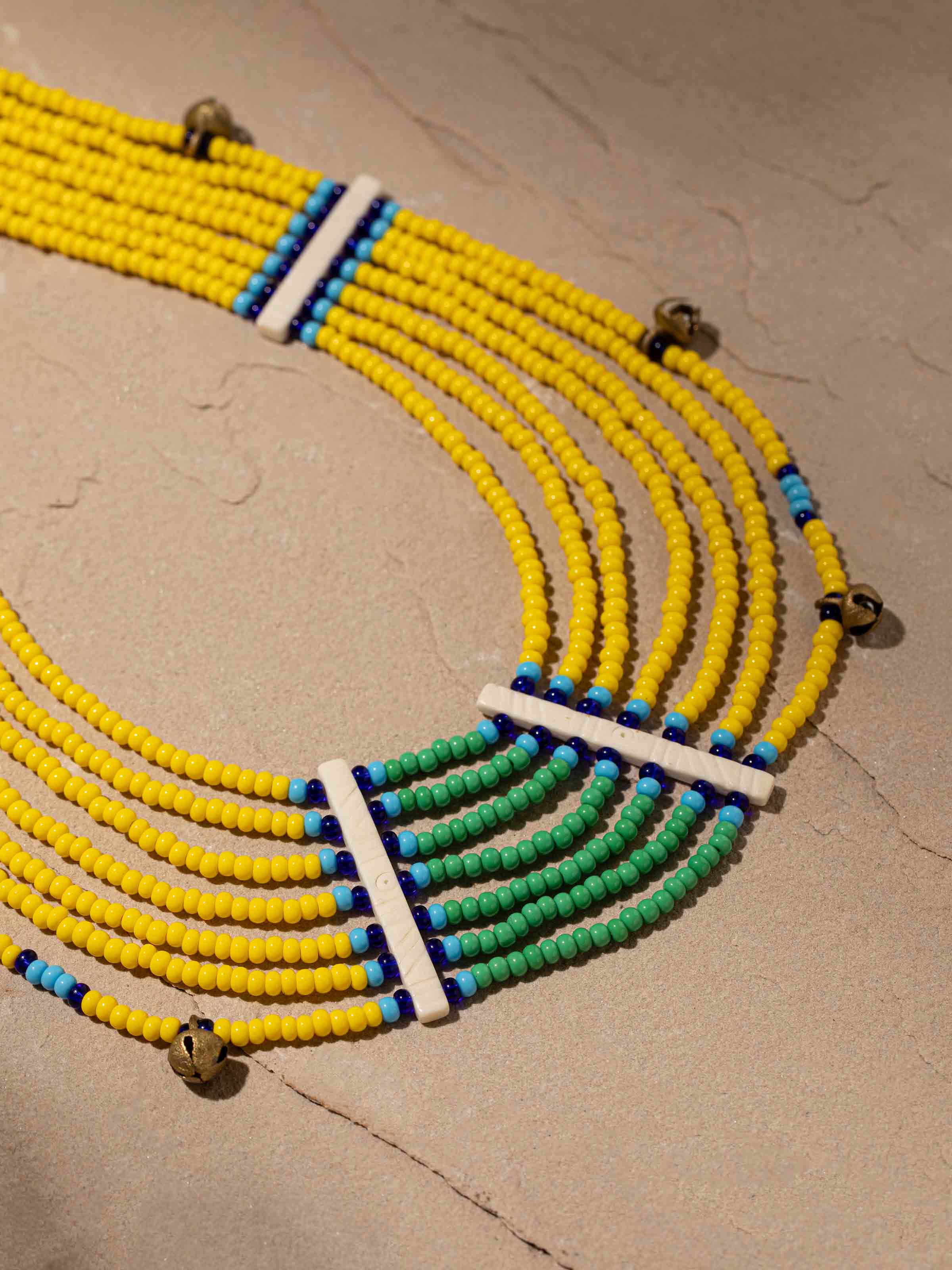 Overhead view of Beads & Faux Bones Collar Necklace featuring a unique design with colorful beads and faux bones.