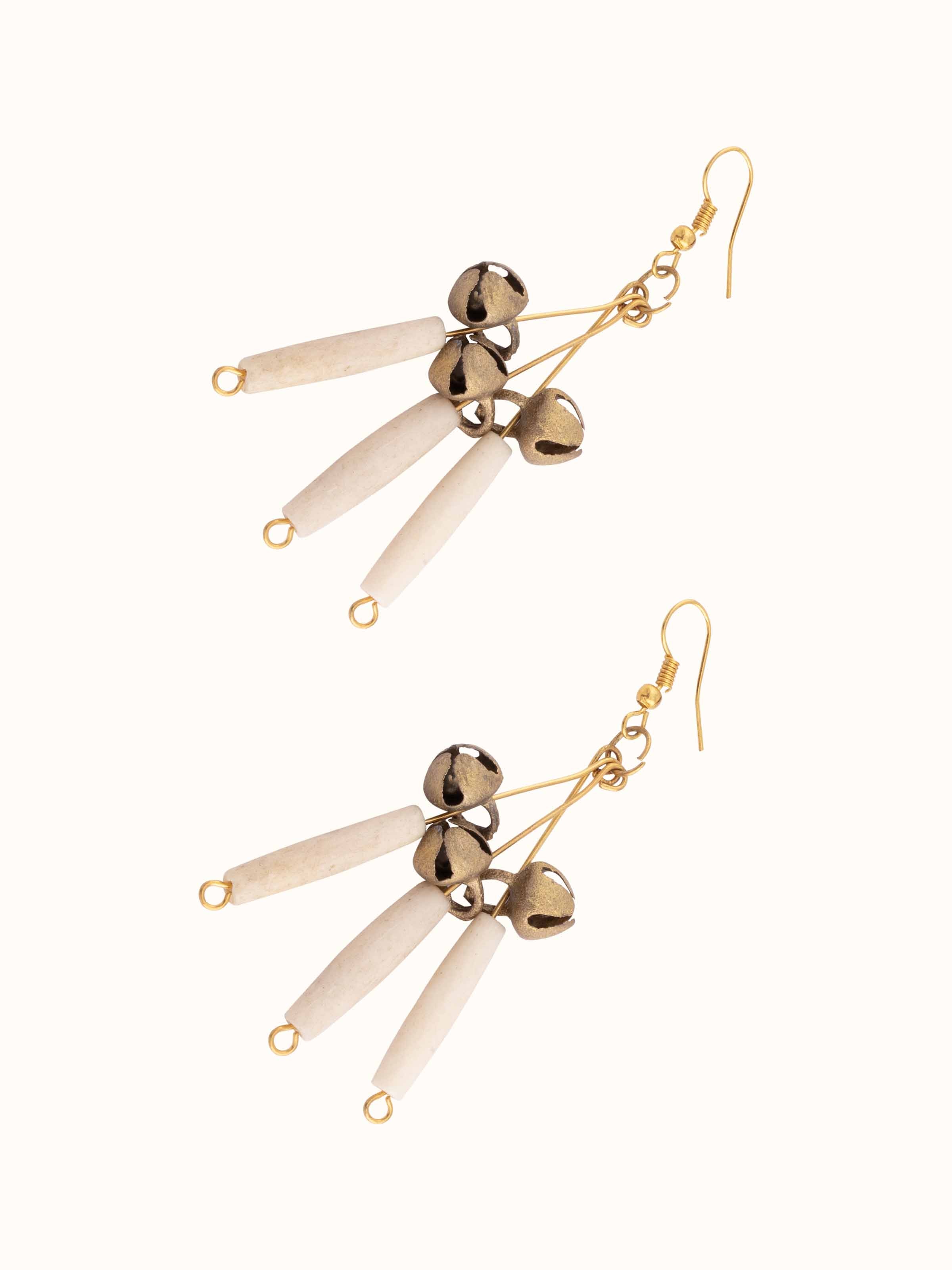 Angled view of Bones & Bells drop earrings highlighting unique elements.