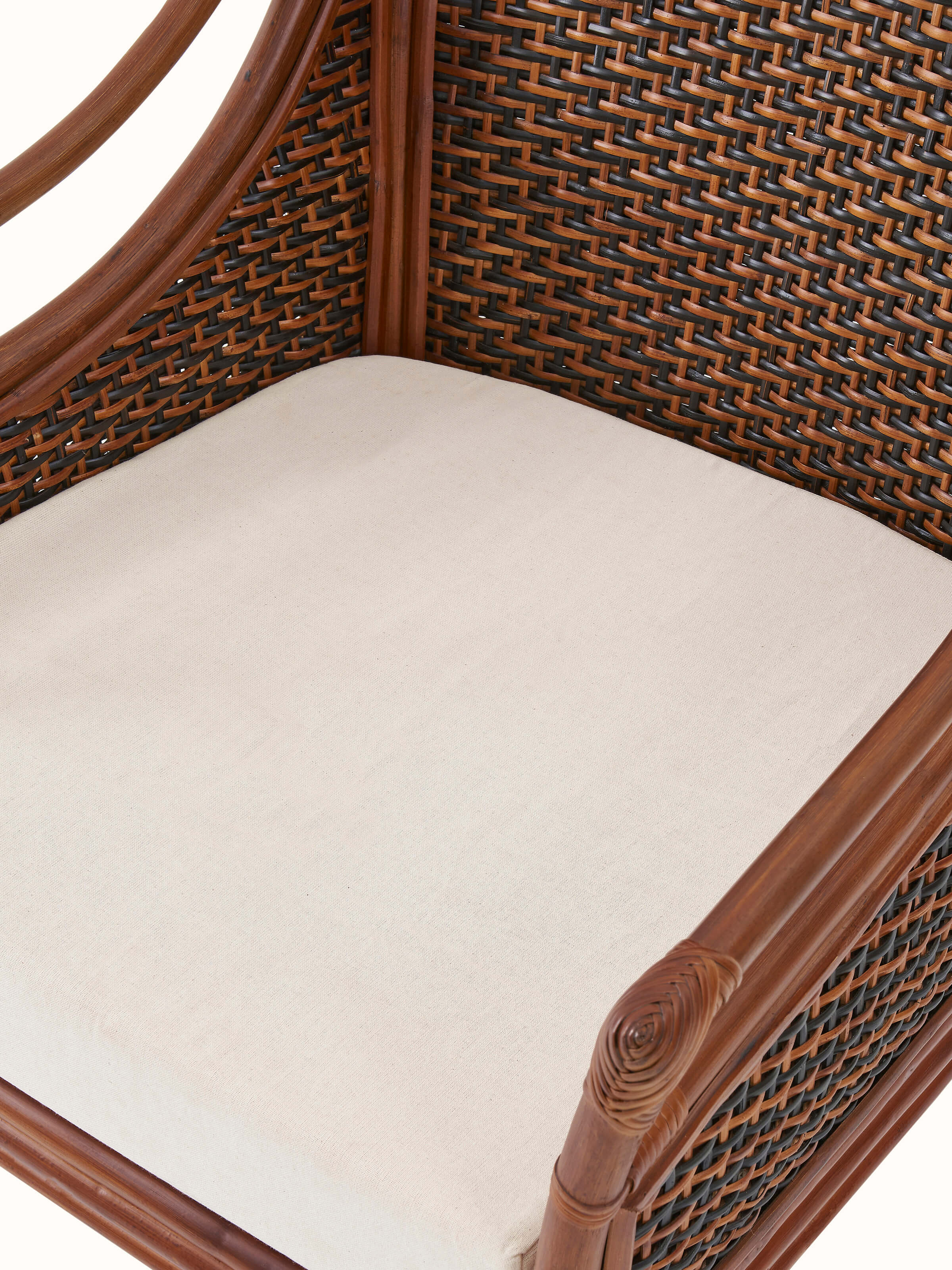 Detailed view of the armrests and cane details on the upholstered armchair, emphasizing craftsmanship.