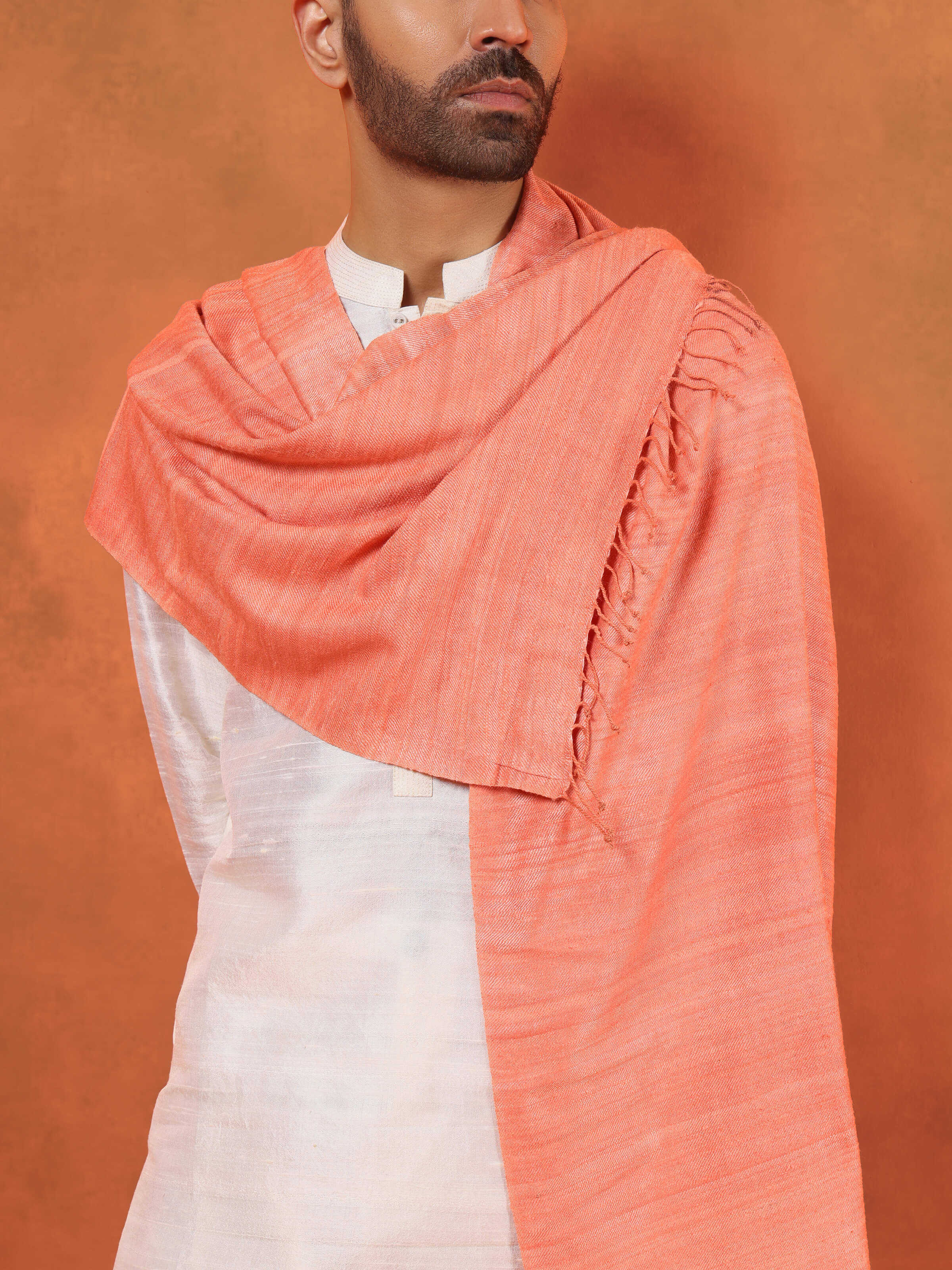 Angled view of peach eri silk stole emphasizing refined silk weave