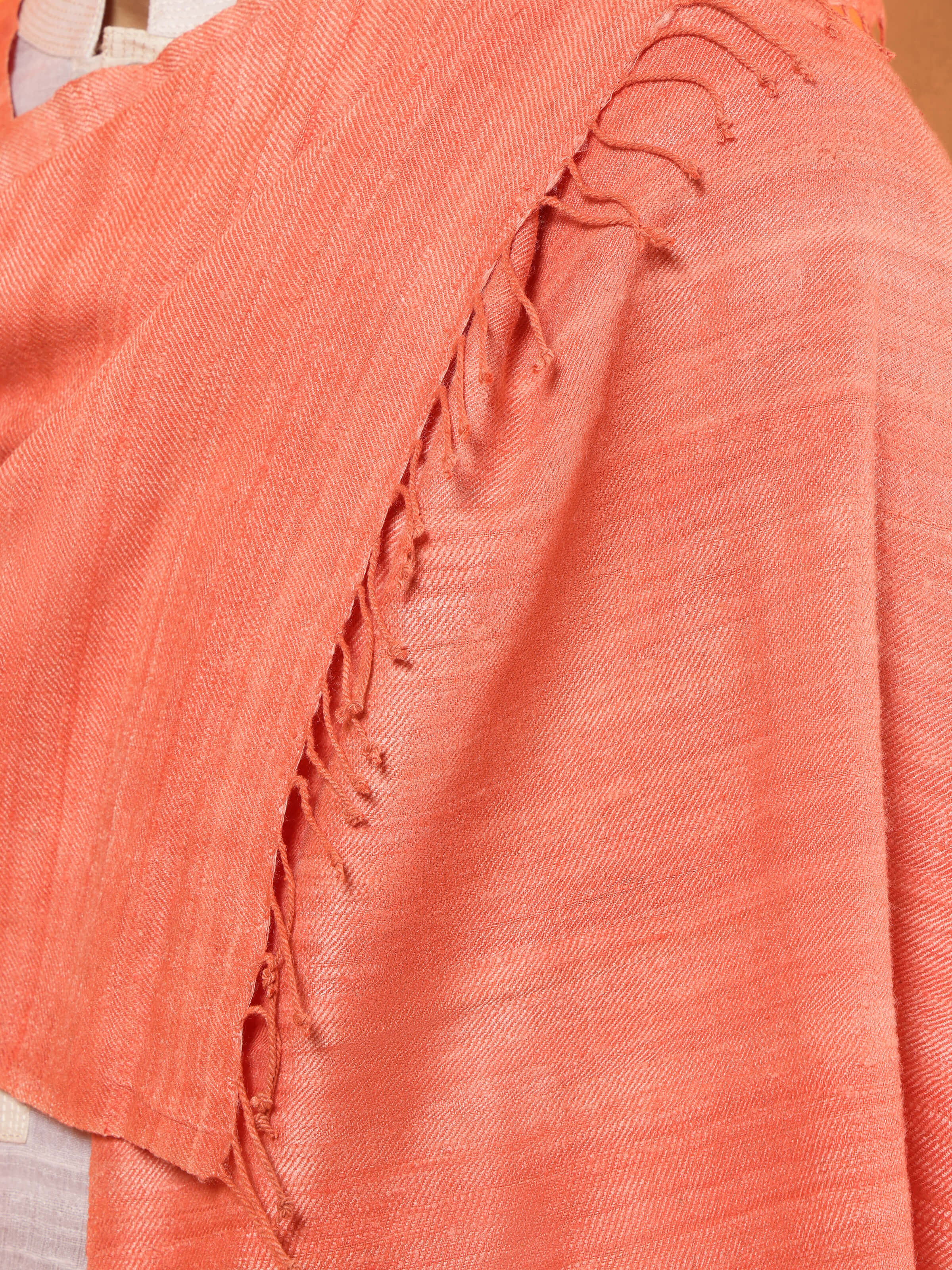 Detail view of peach eri silk stole showcasing fabric texture and craftsmanship