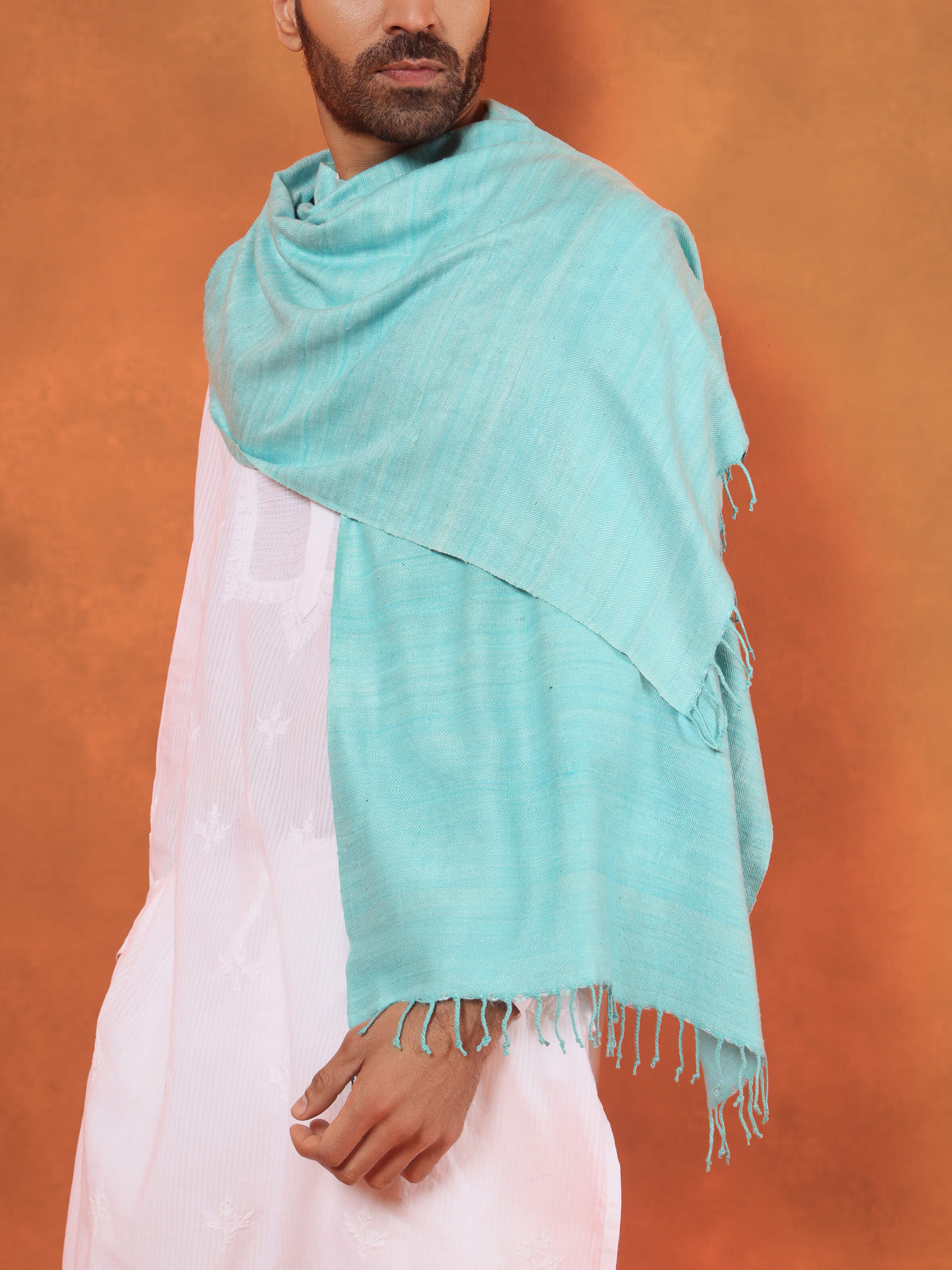 Angled view of aqua eri silk stole emphasizing subtle sheen and refined weave