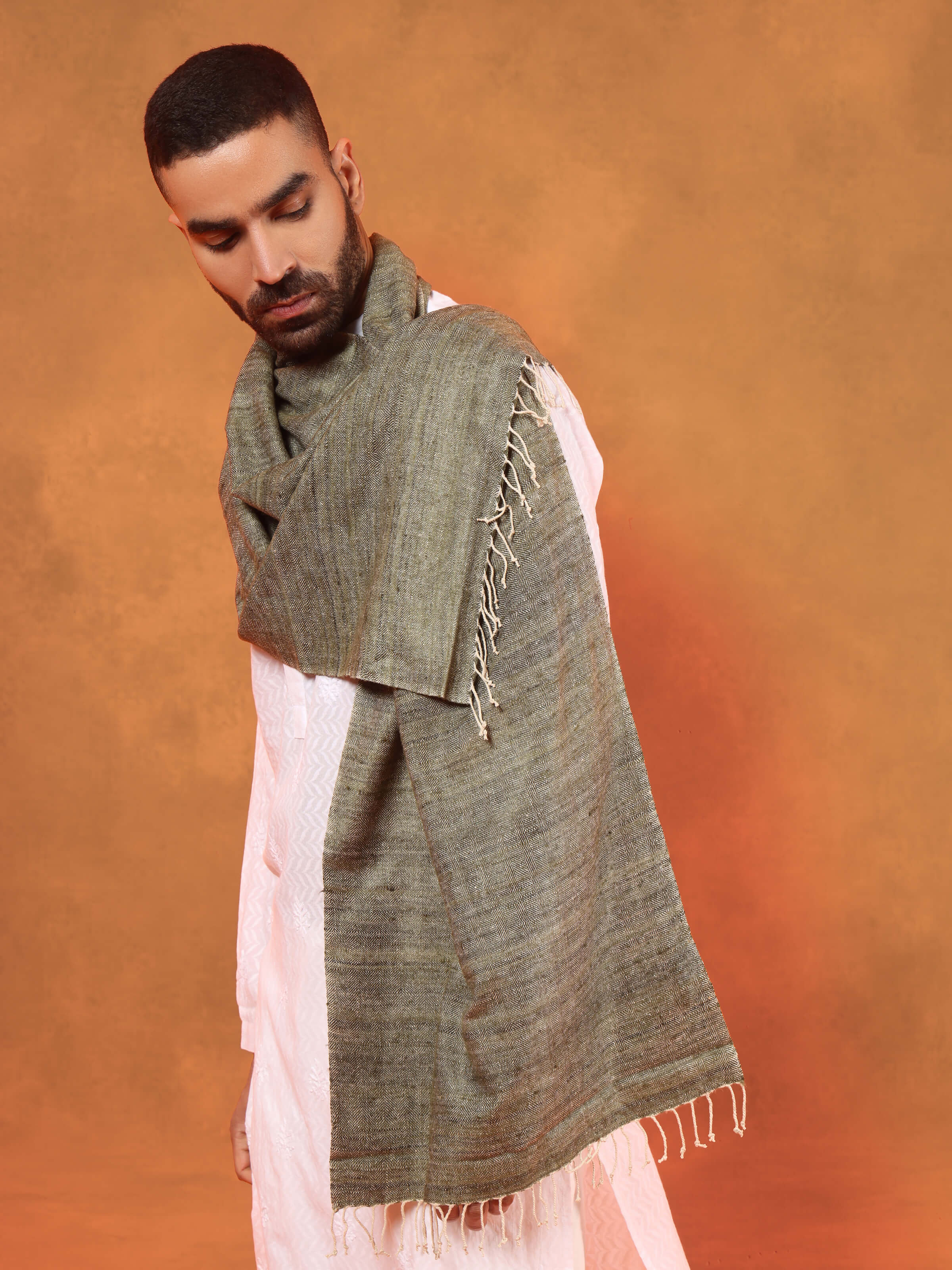 Angled view capturing the soft drape and flow of green Eri silk stole