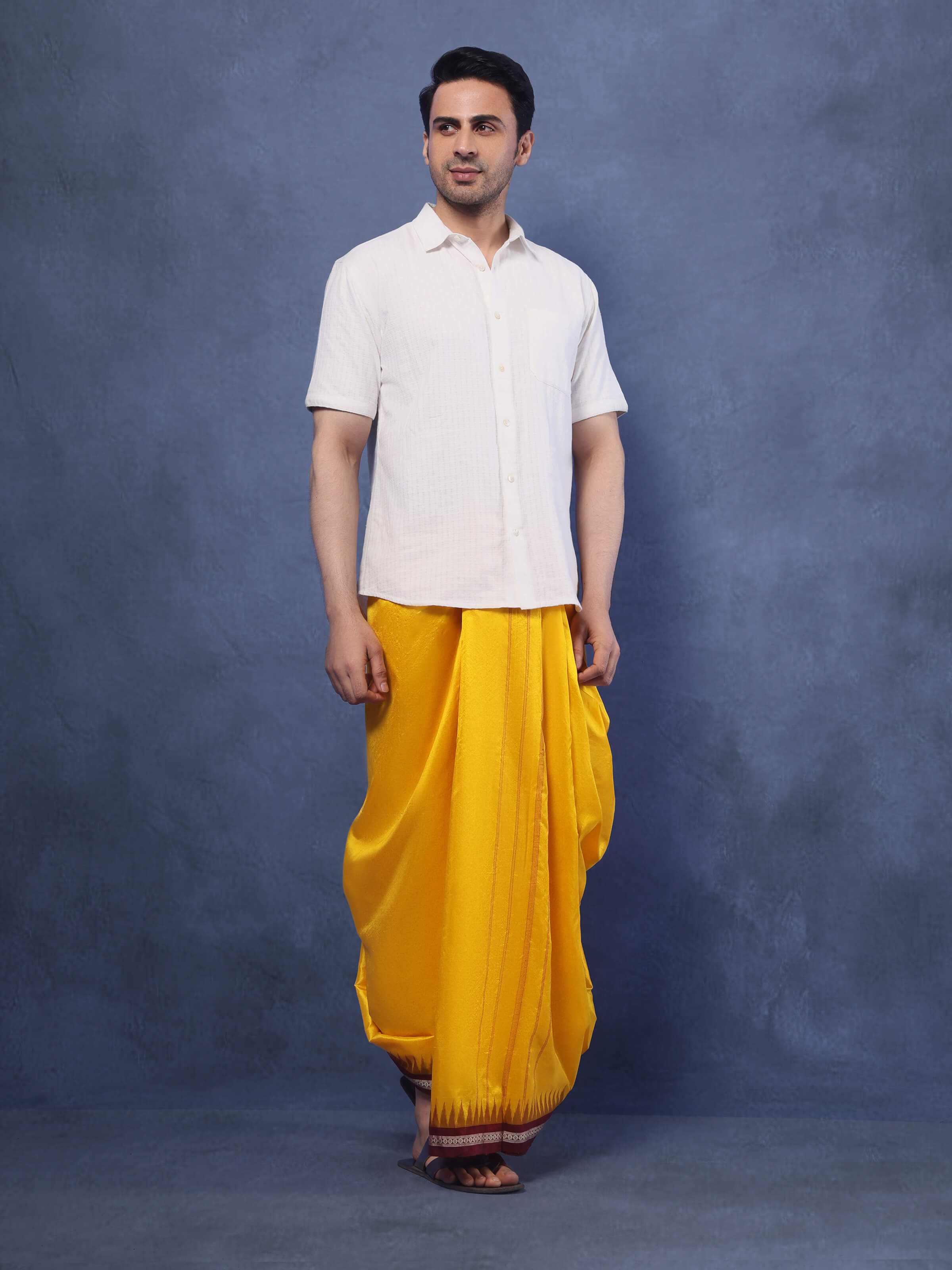 Lifestyle shot of Yellow Mulberry Silk Dhoti fabric spread out, showcasing fabric fall