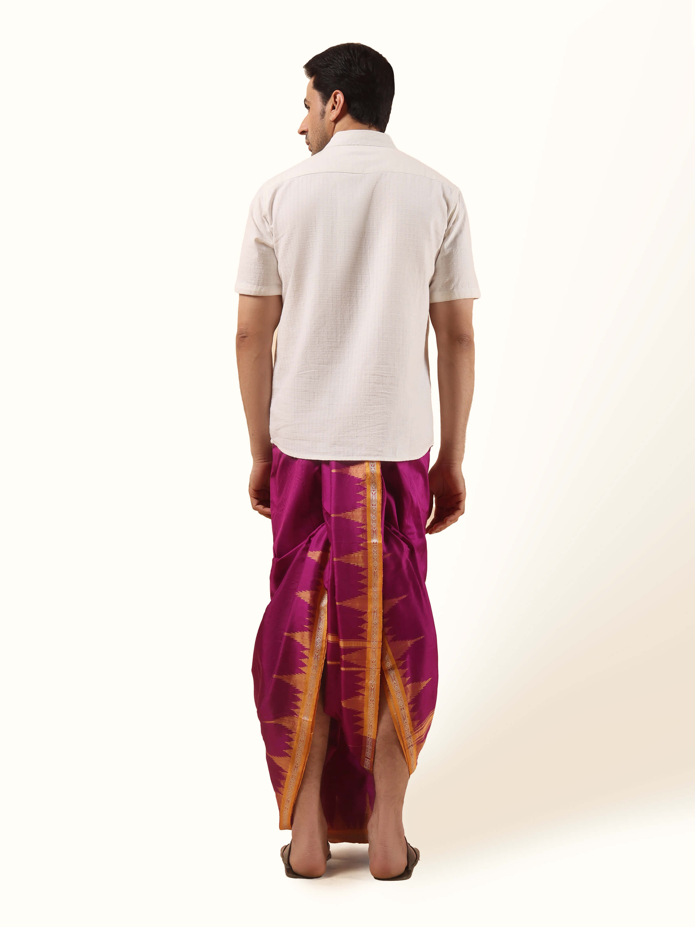 Rear view of folded purple mulberry silk dhoti fabric emphasizing rich color and smooth surface.