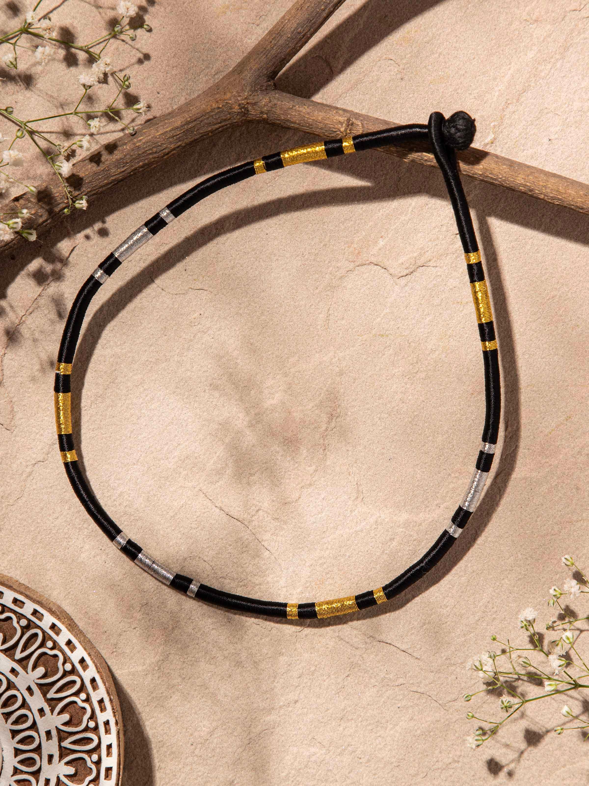 Angled view of Patwa Collar Necklace highlighting the vibrant threadwork and intricate design.