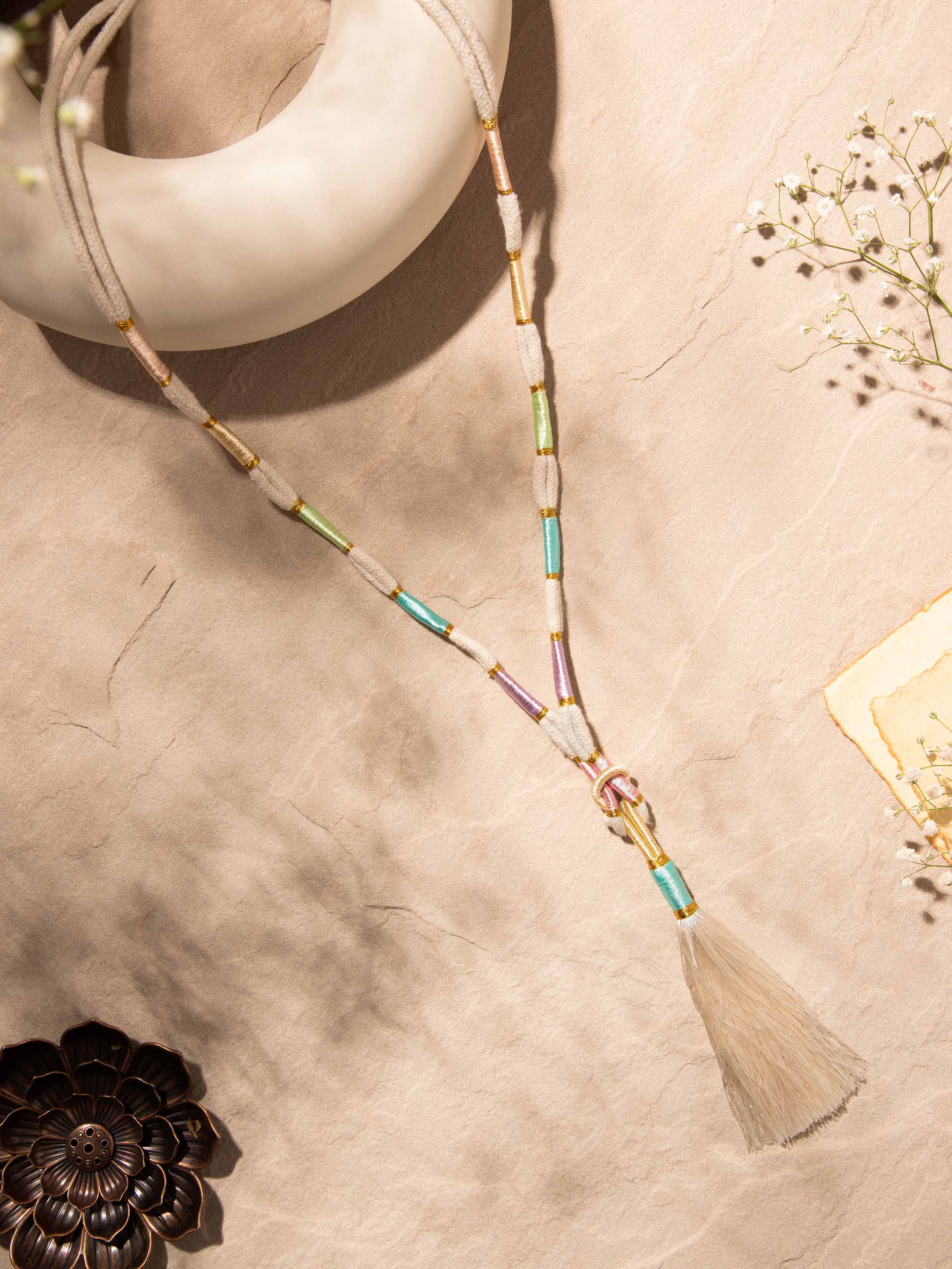 Side view of Patwa long necklace highlighting its detailed embroidery and traditional patterns